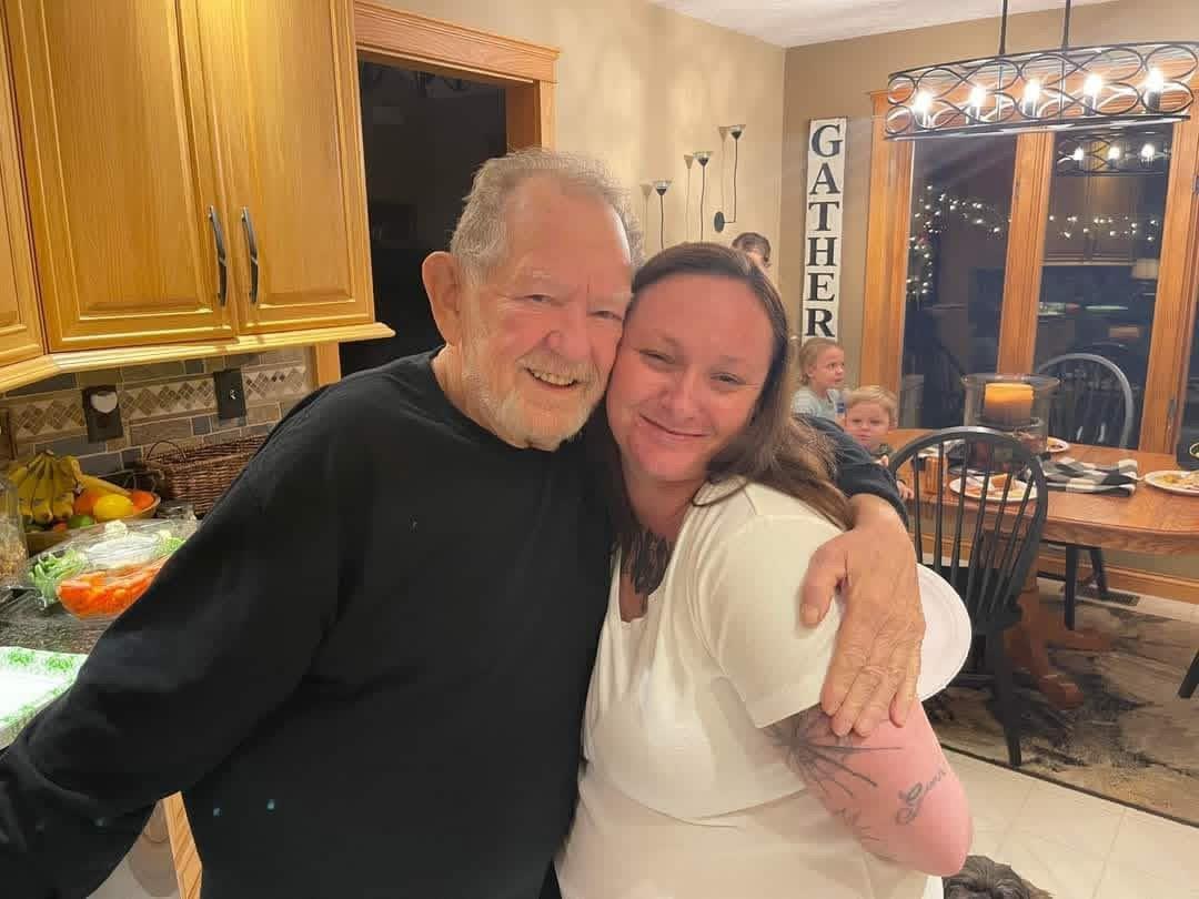A man and woman hugging in a room