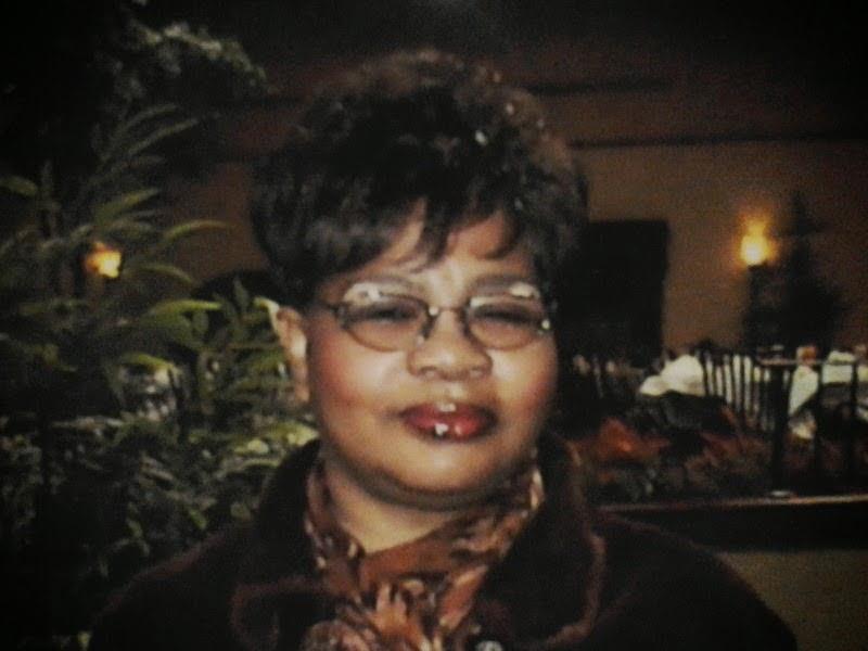 A woman with short hair wearing glasses