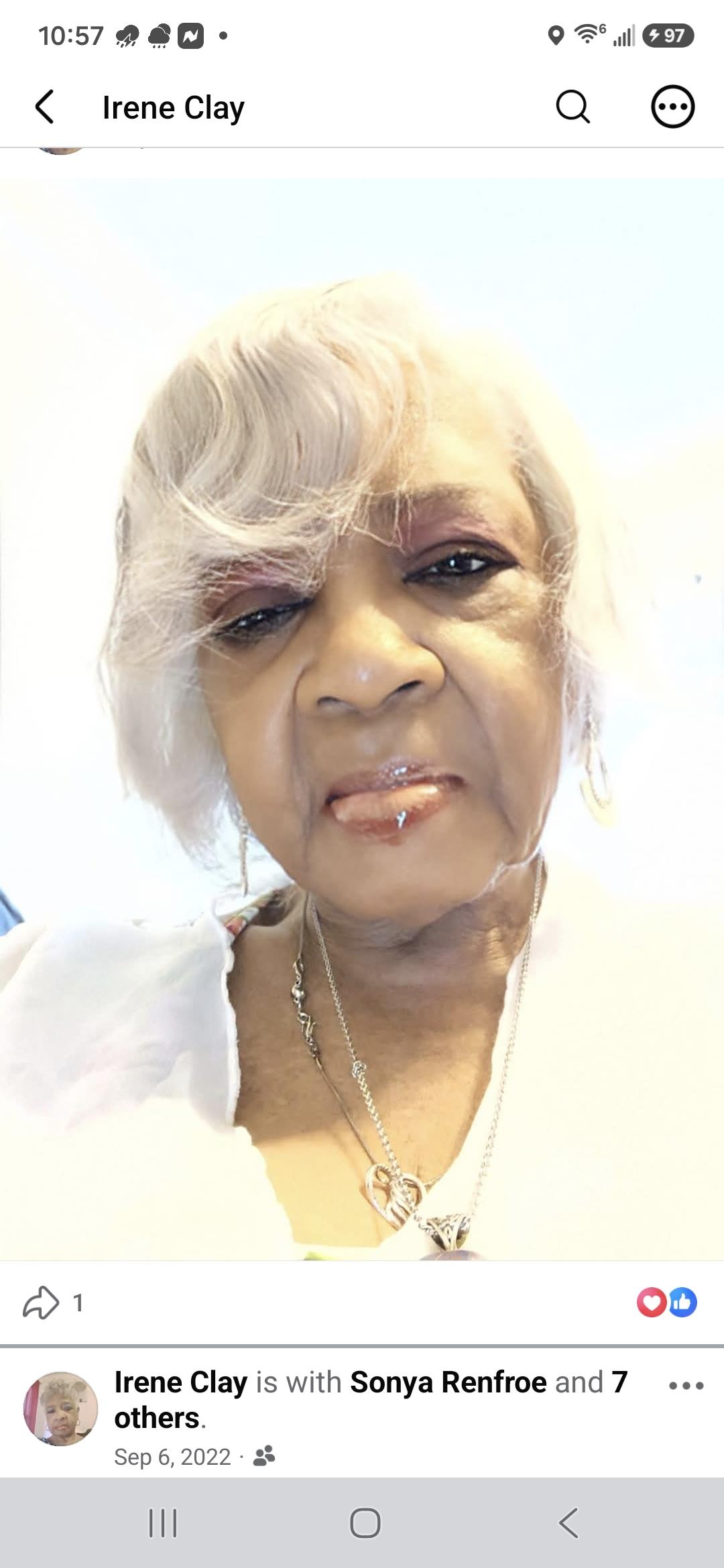 A woman with white hair and a white shirt