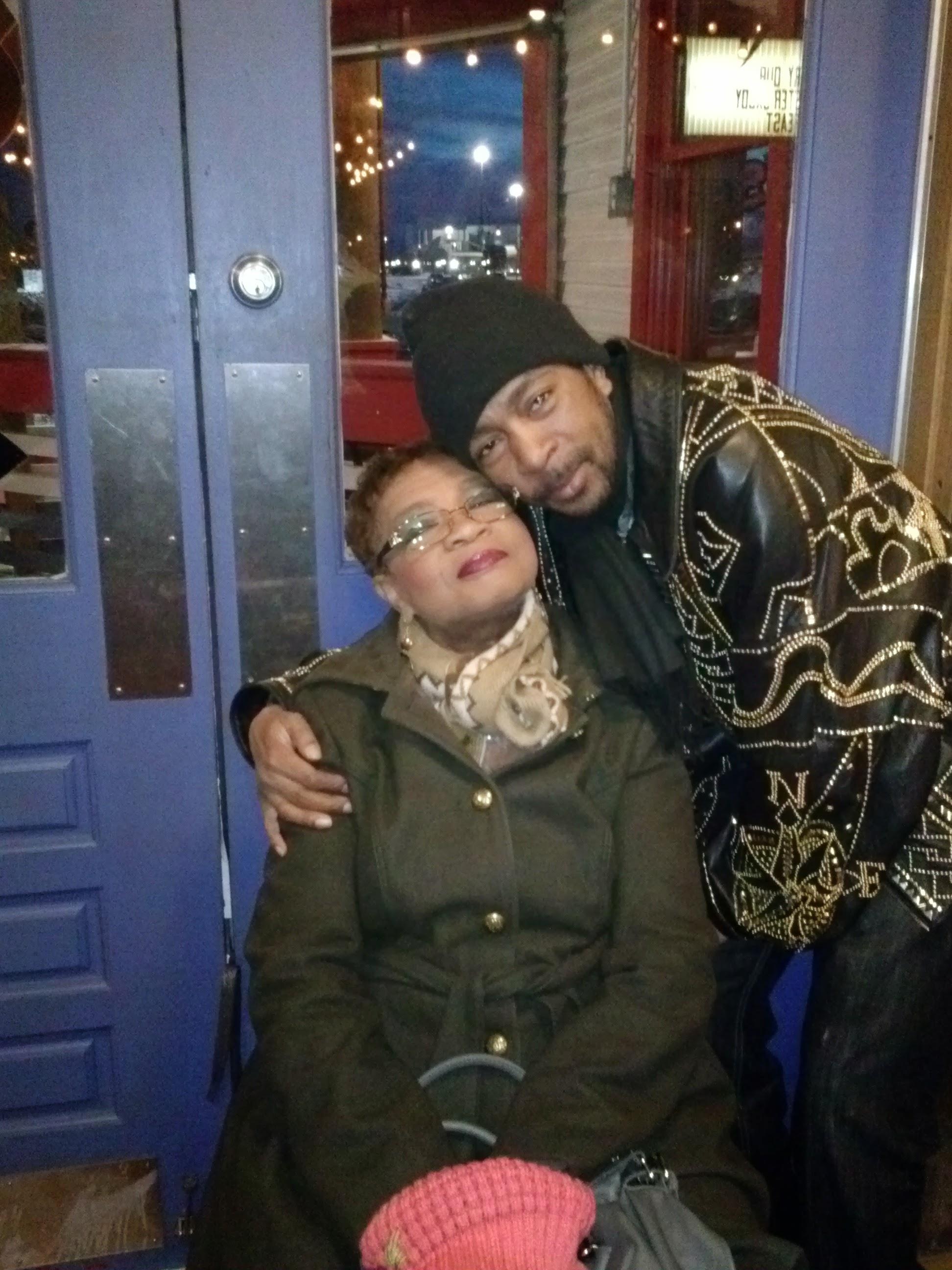 A man and woman sitting in a chair