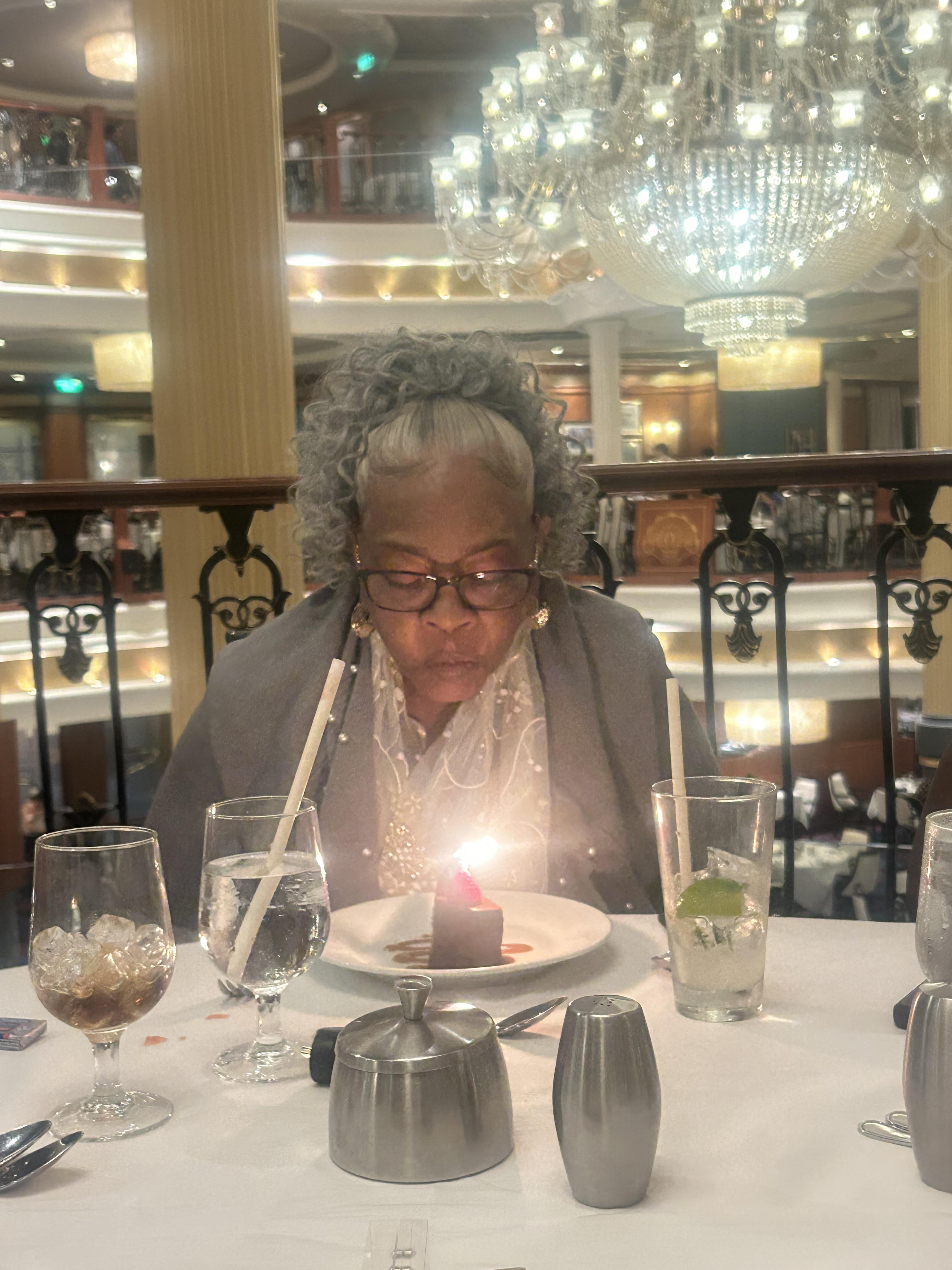 A woman sitting at a table with a candle