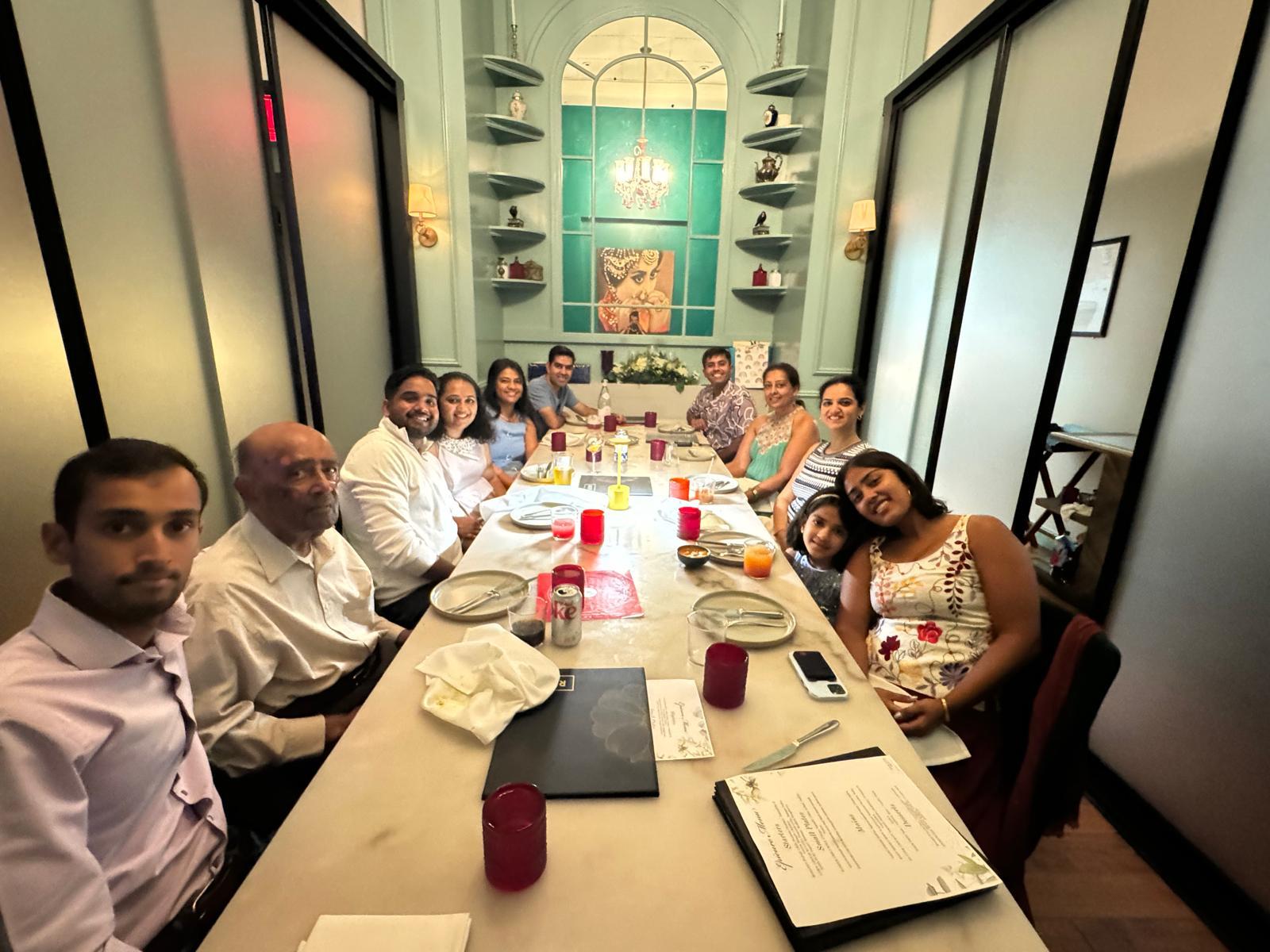 A group of people sitting at a long table