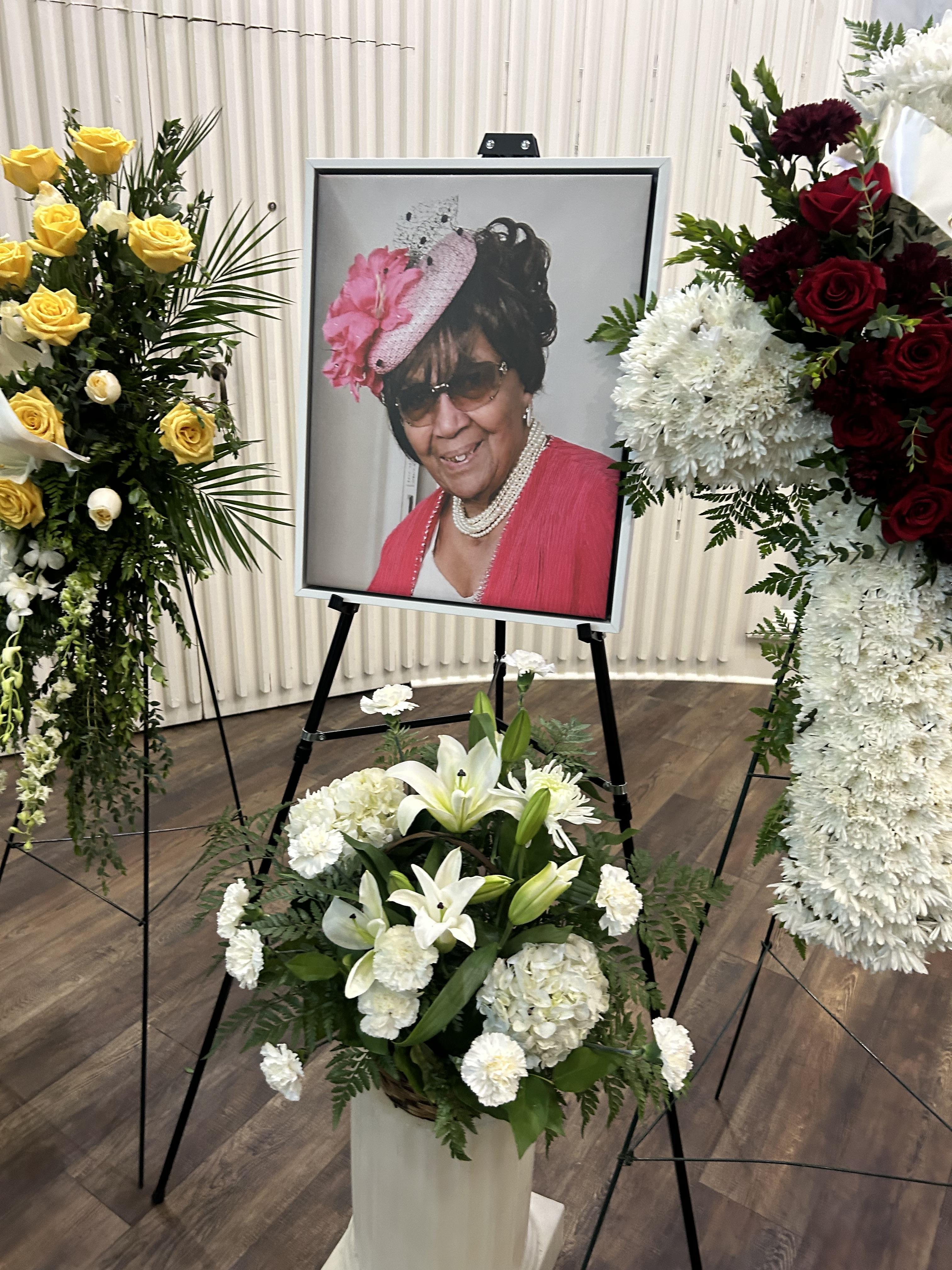 A picture of a woman in a pink dress and a bouquet of flowers