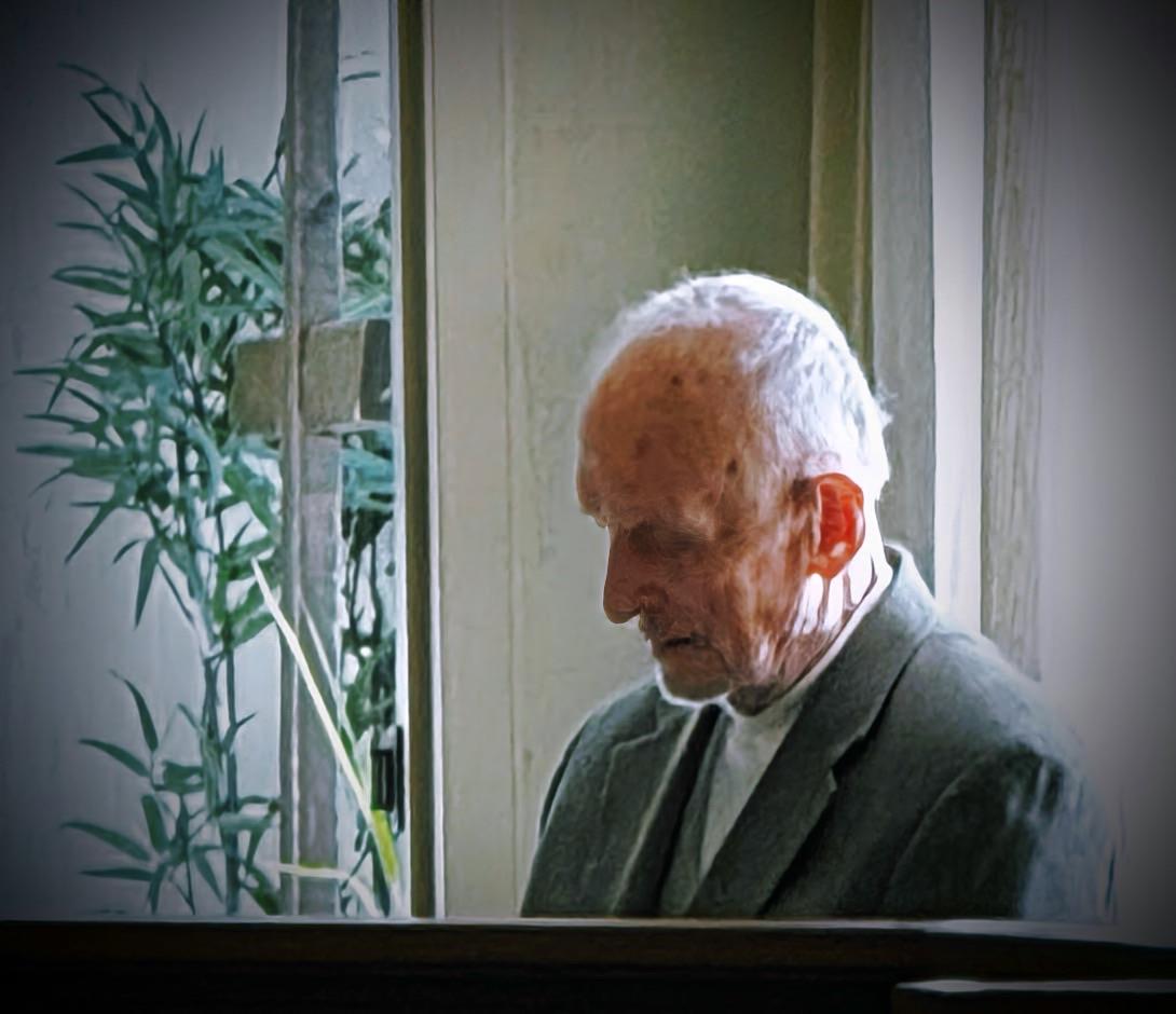 An old man looking out a window