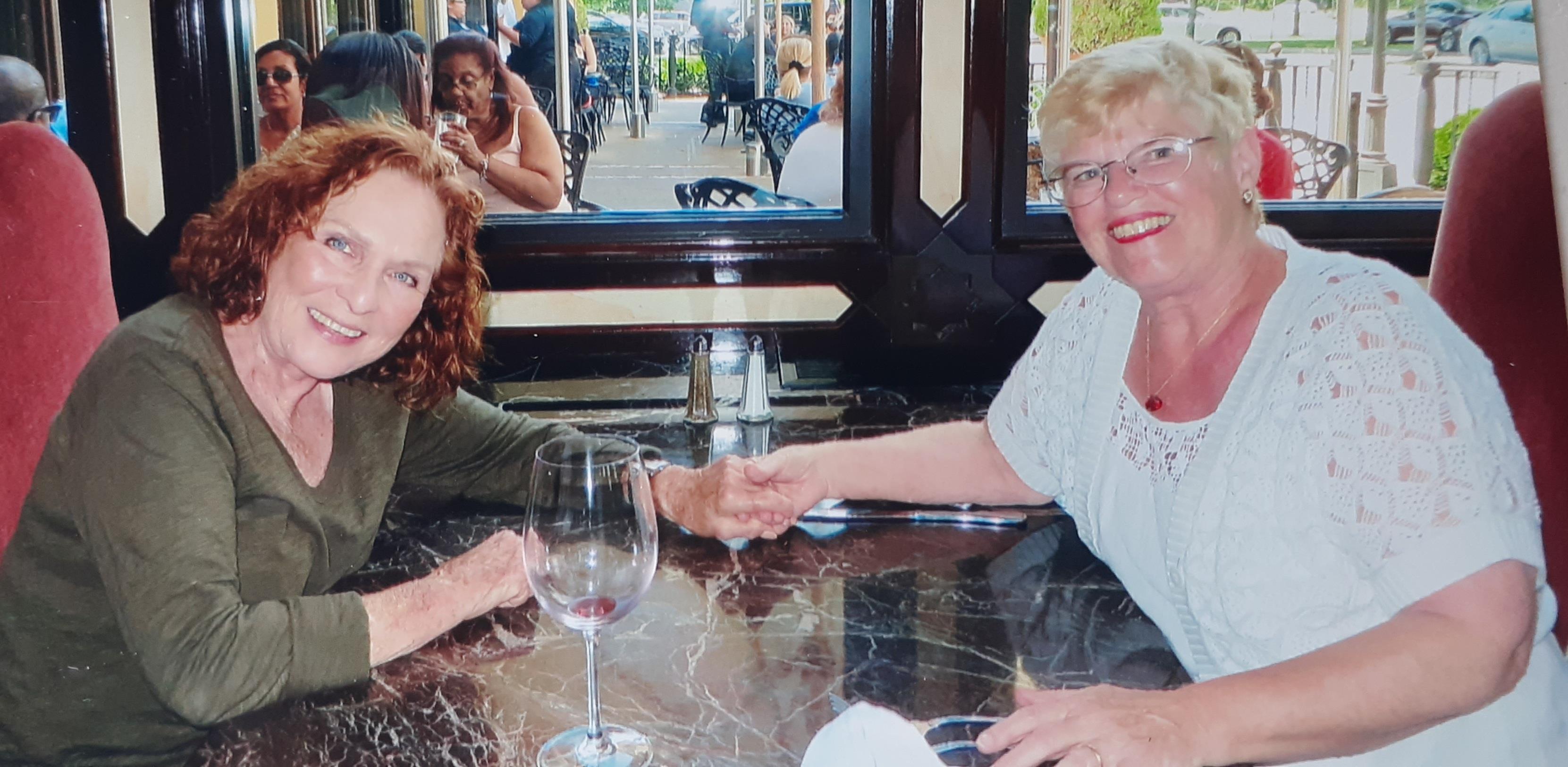 A couple of women sitting at a table