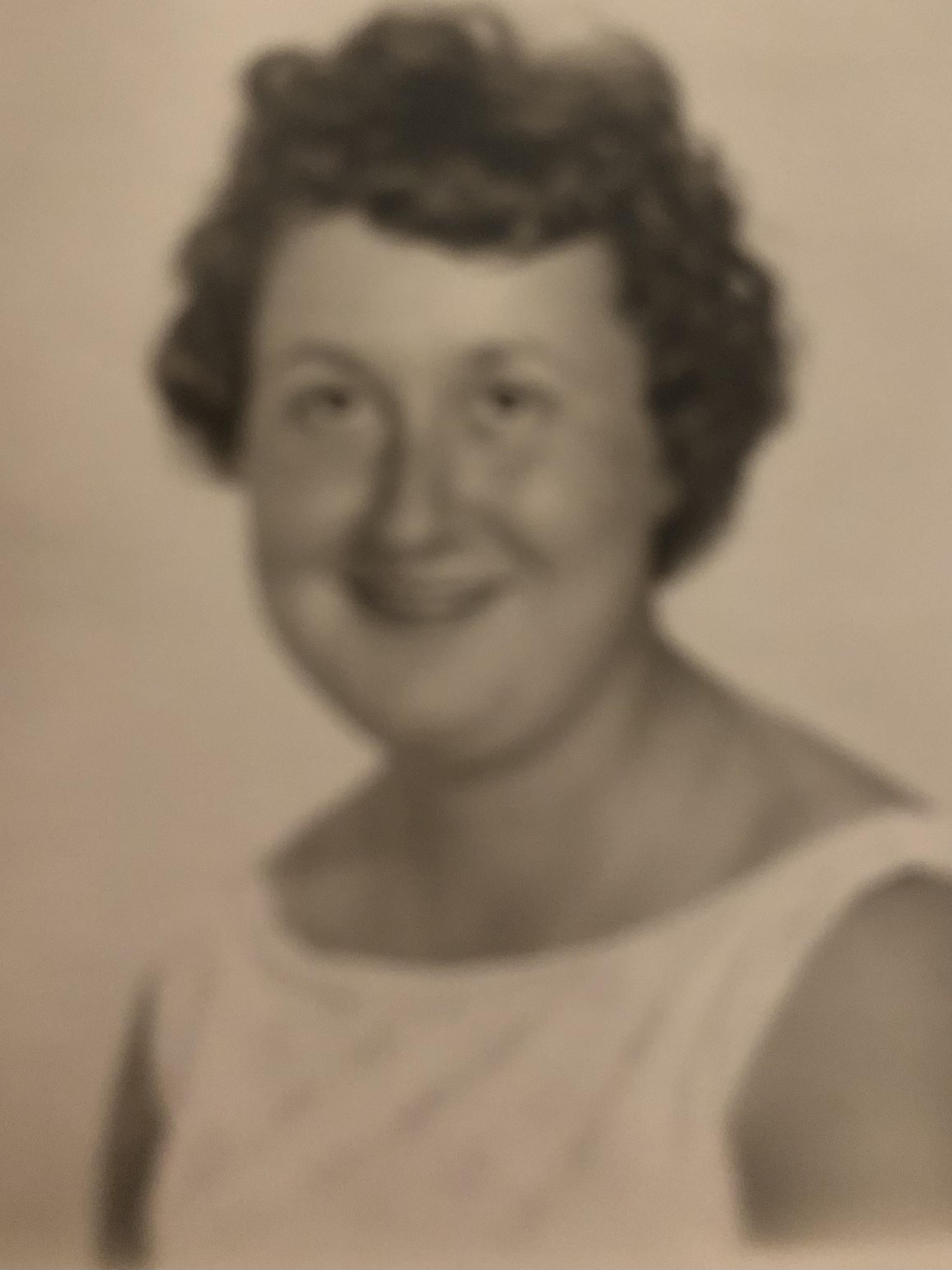 A woman in a white tank top