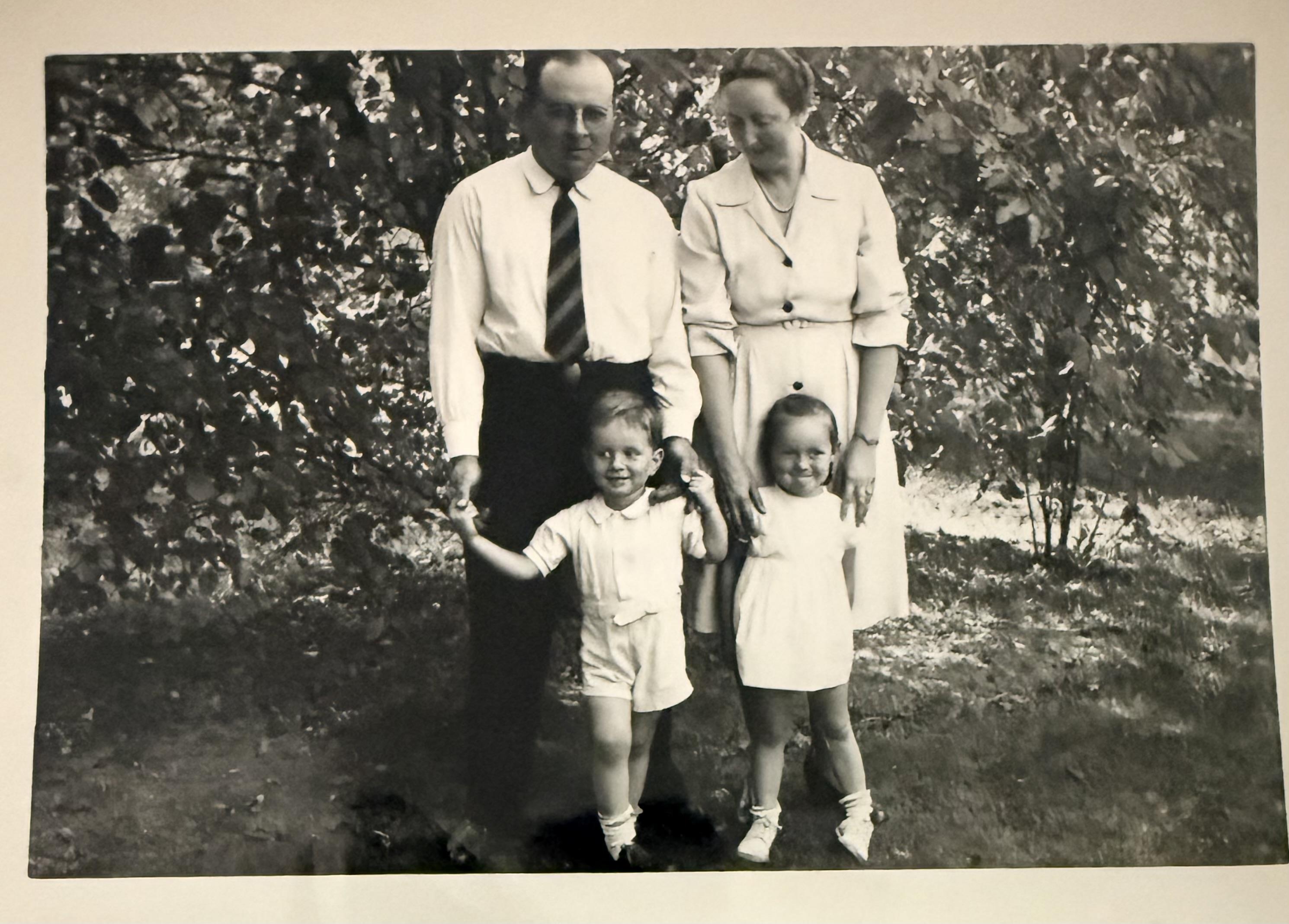 A man and woman standing with children