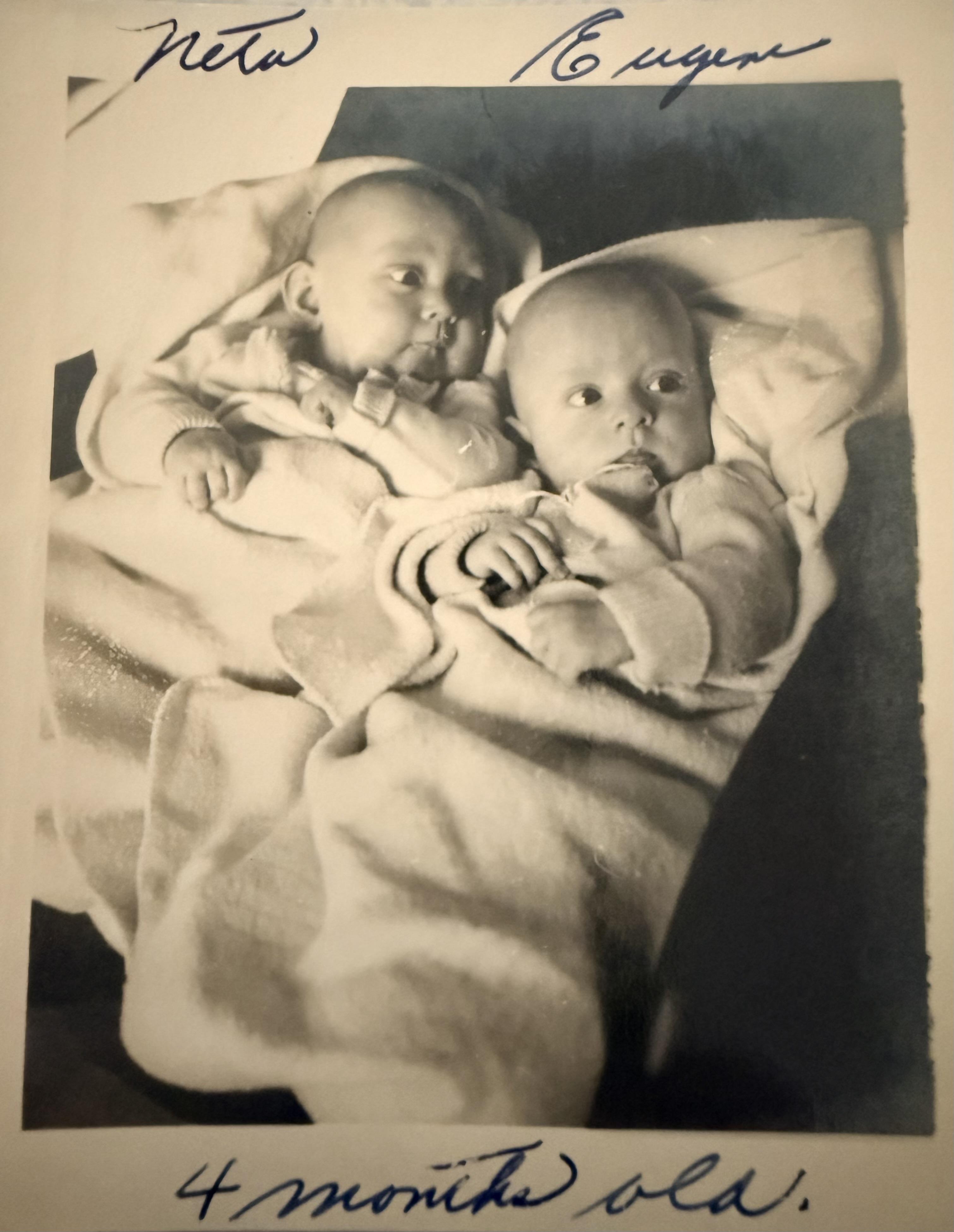 A black and white photo of babies
