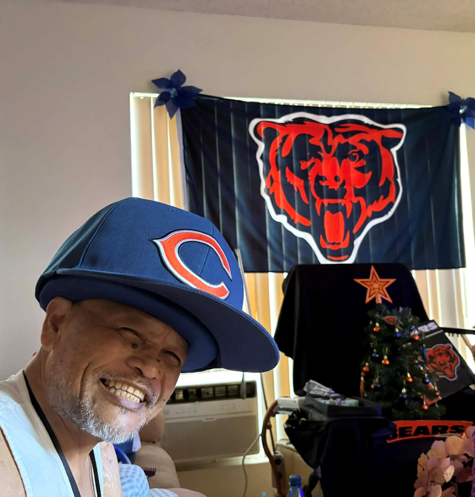 A man smiling with a hat