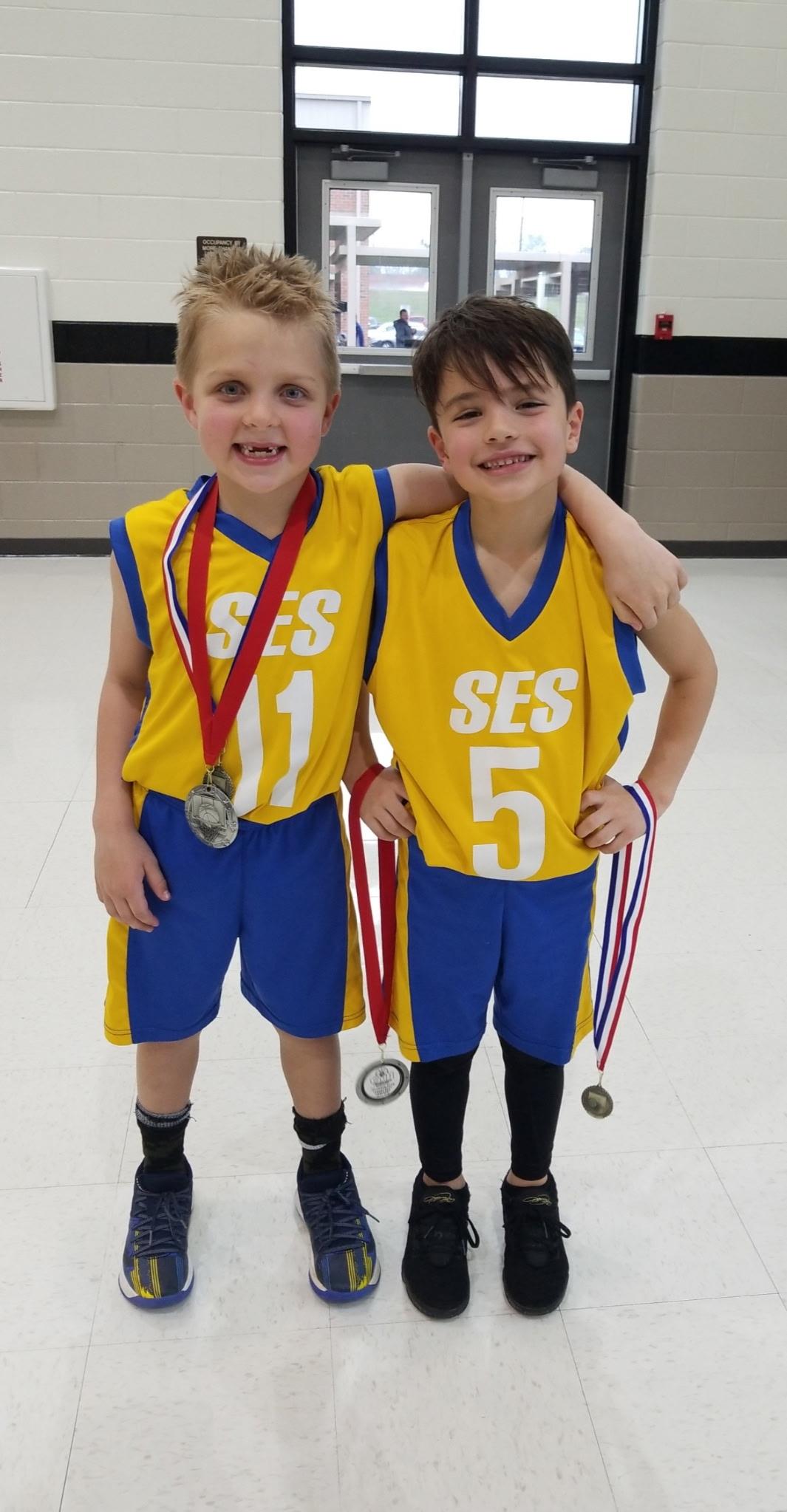 Two boys wearing sports uniforms