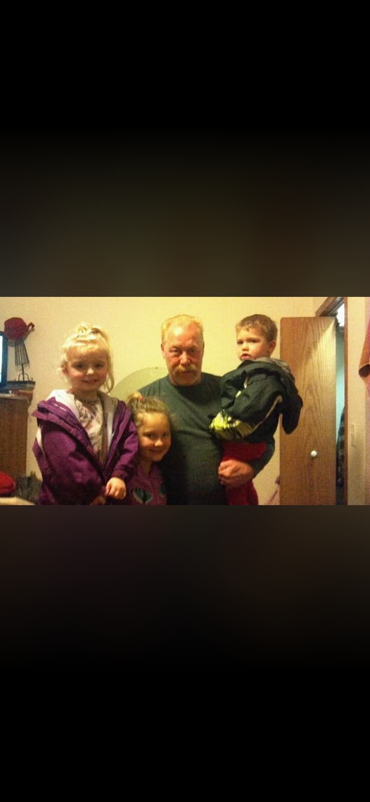 A man holding two children