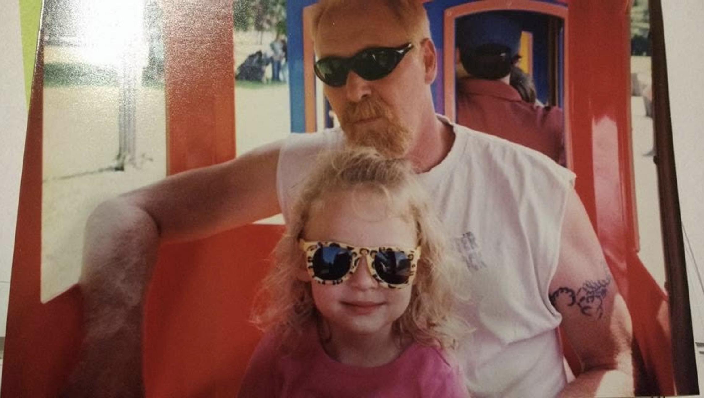 A man and a girl wearing sunglasses