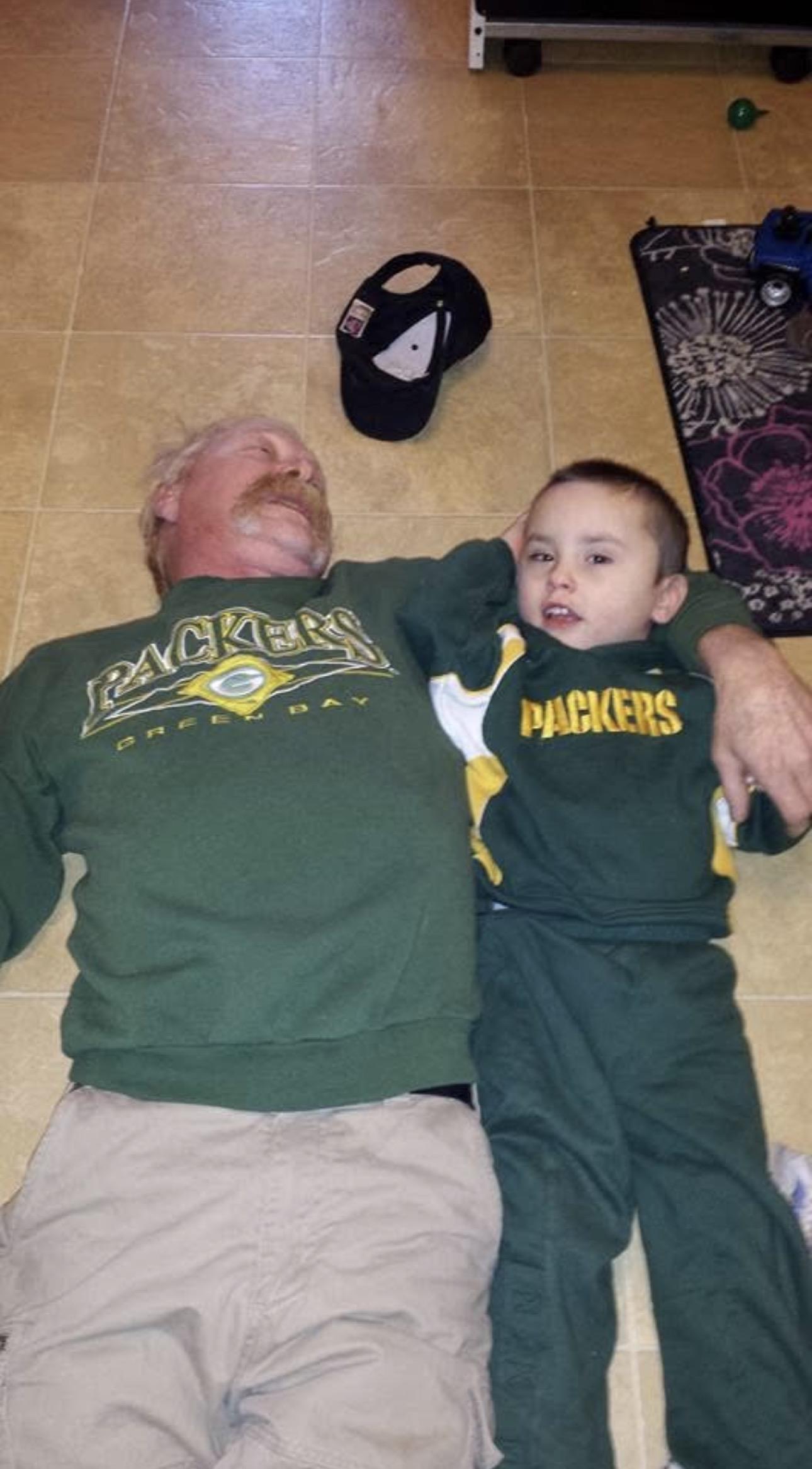 A man and boy lying on the floor