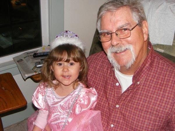 A man and a little girl posing for a picture