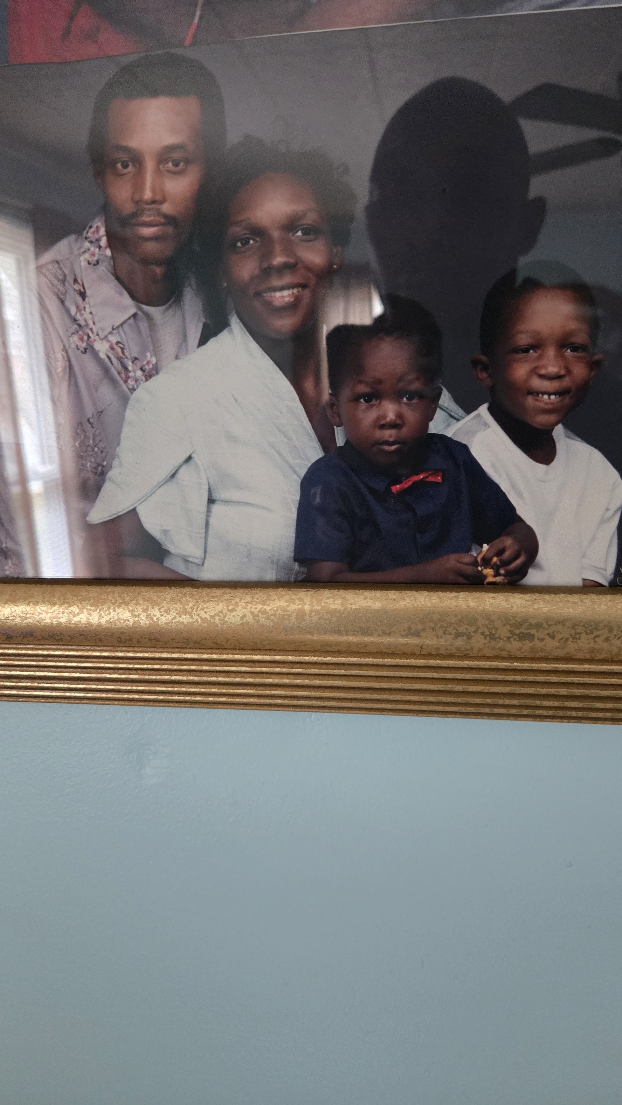 A framed picture of a family