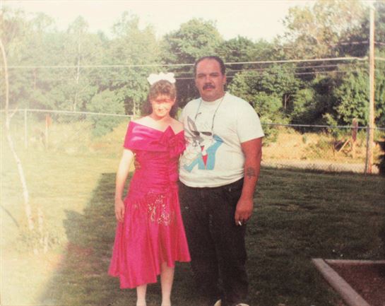 A man and woman standing in a yard