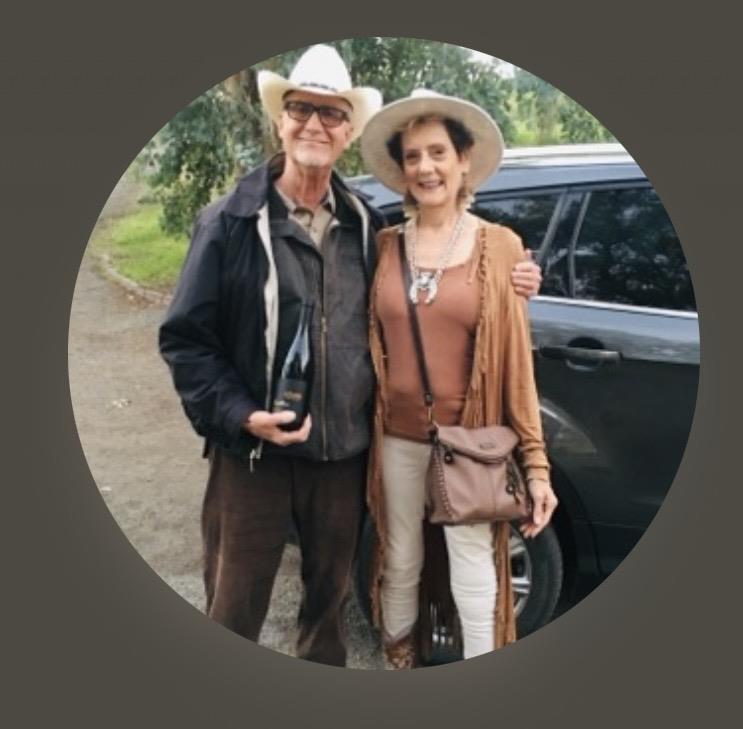 A man and woman standing next to a car