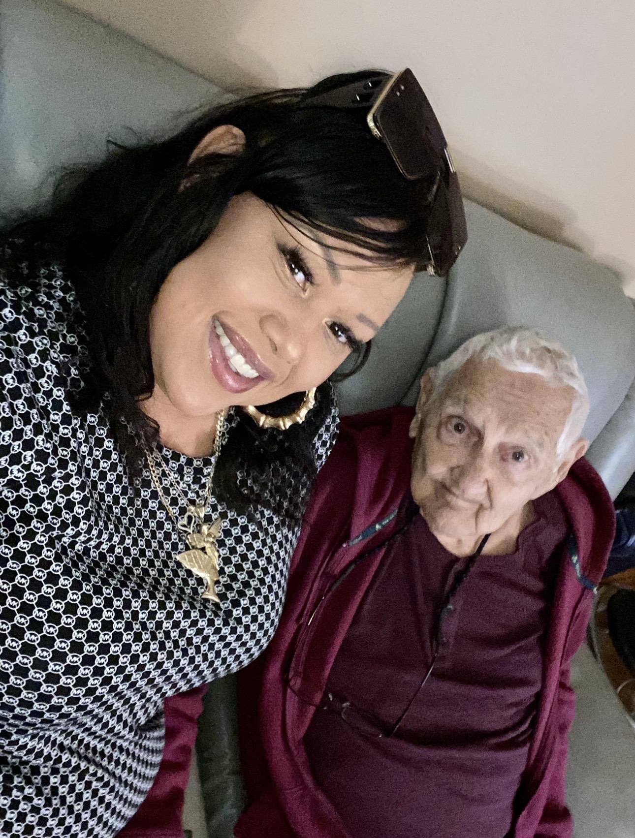 A woman taking a selfie with an elderly woman