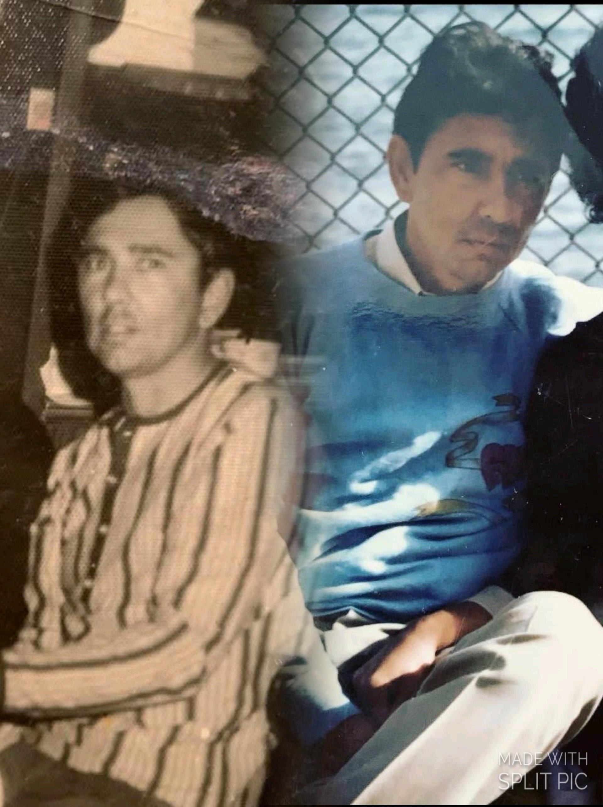 A man sitting next to a fence