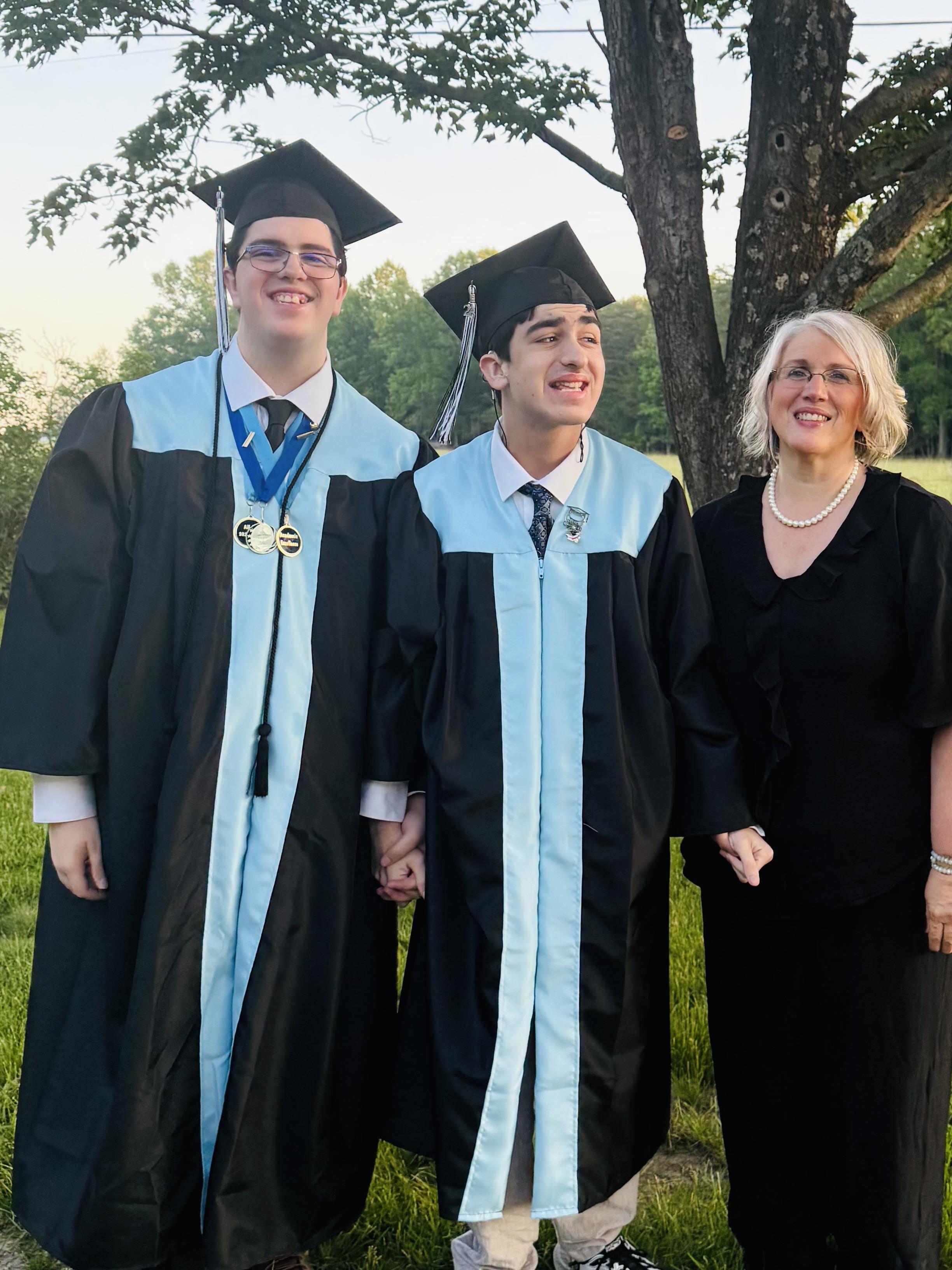 A group of people in graduation gowns and cap and gowns