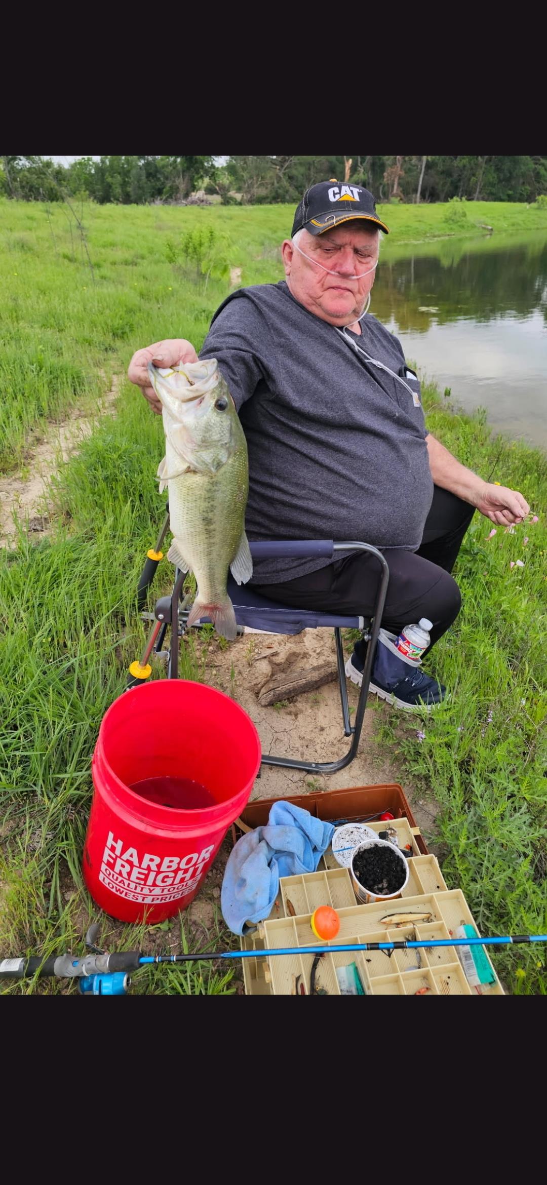 A man sitting in a chair holding a fish