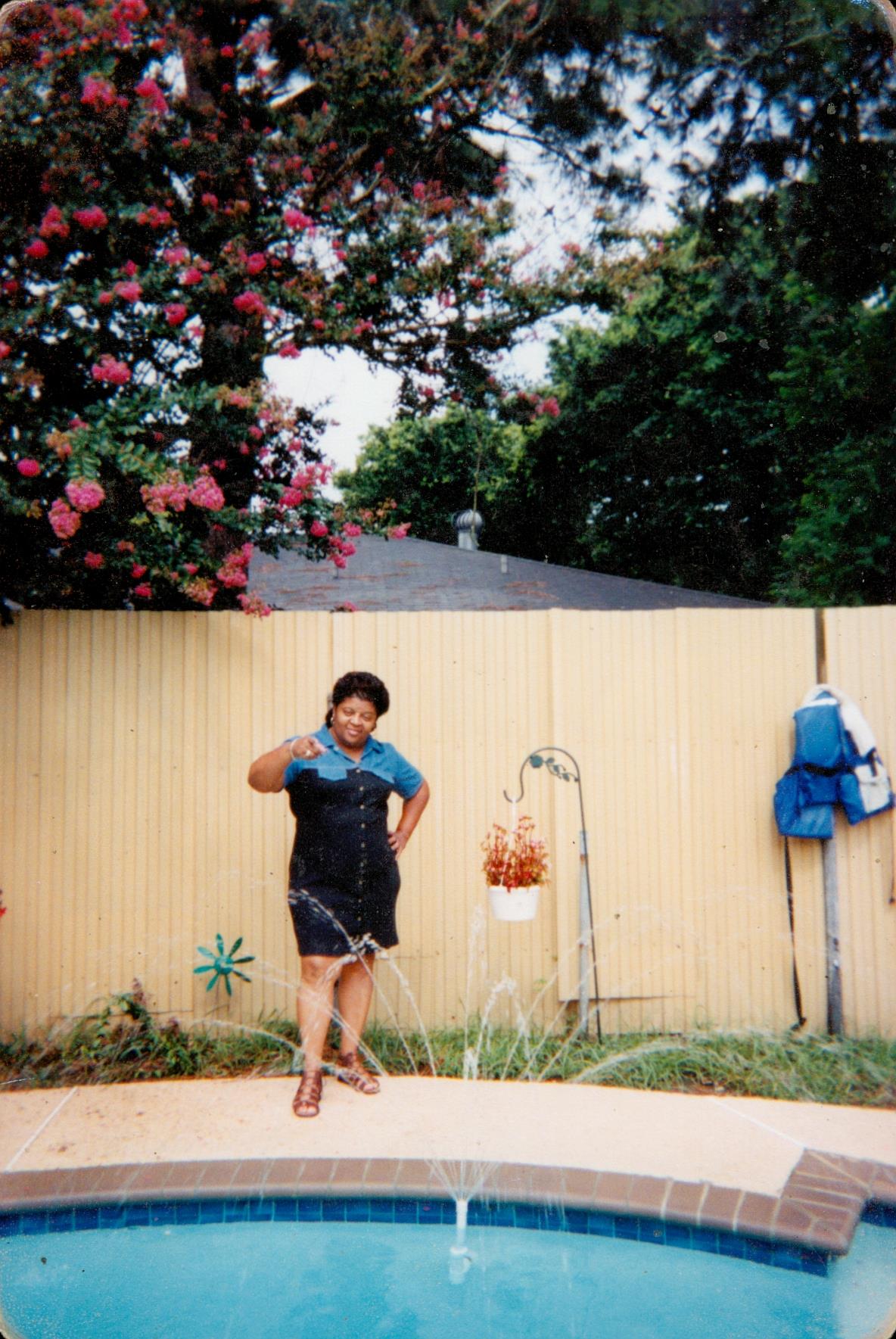 A woman standing in front of a fence