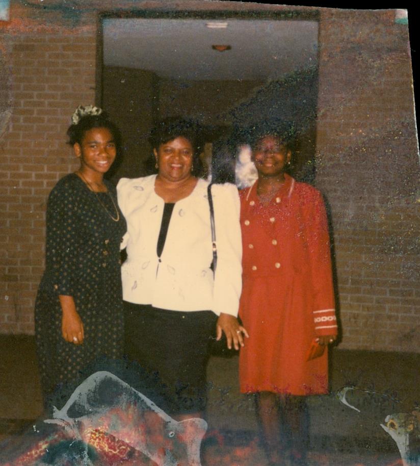 A group of women standing in front of a brick building