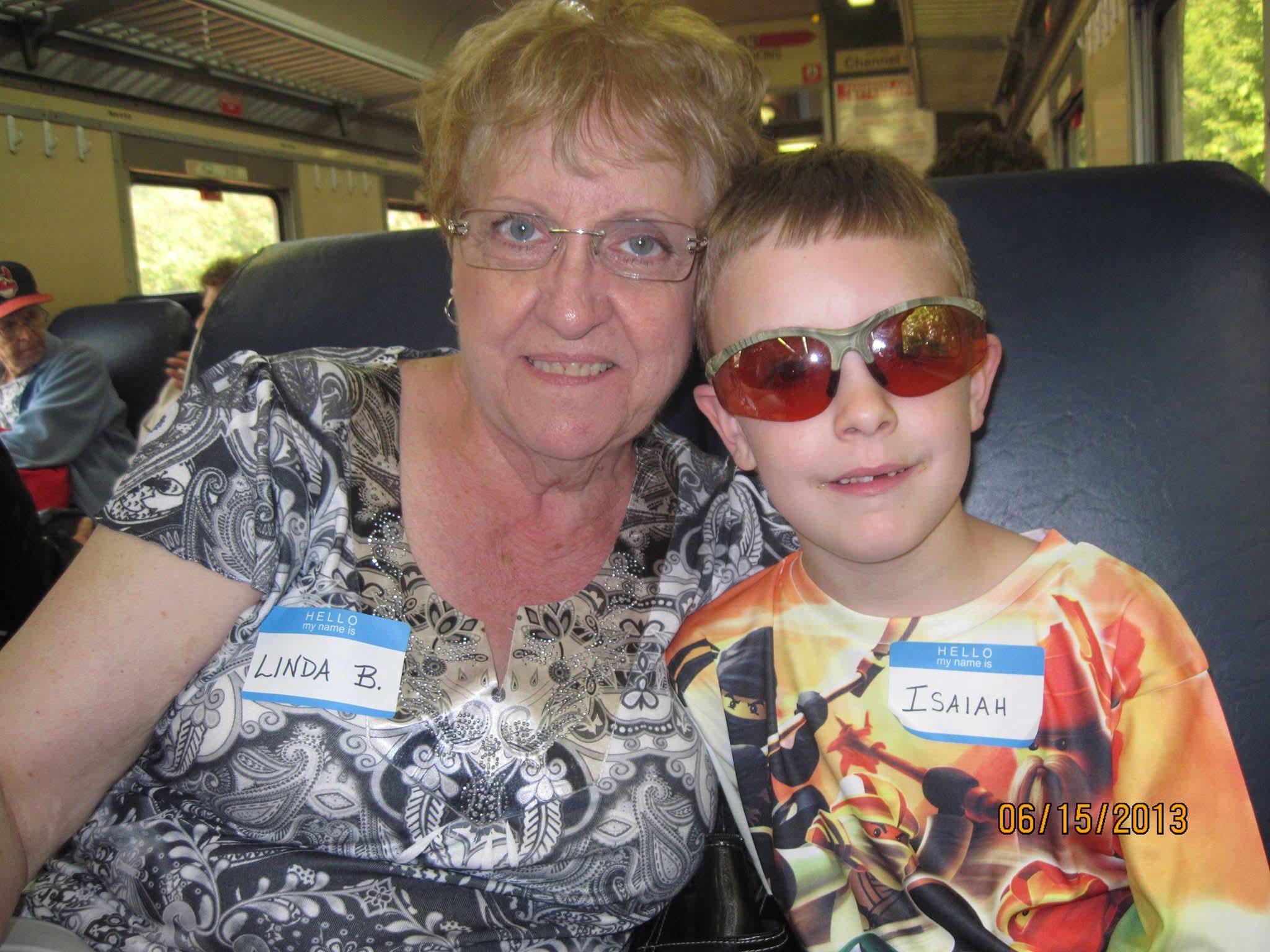 A woman and boy sitting on a train