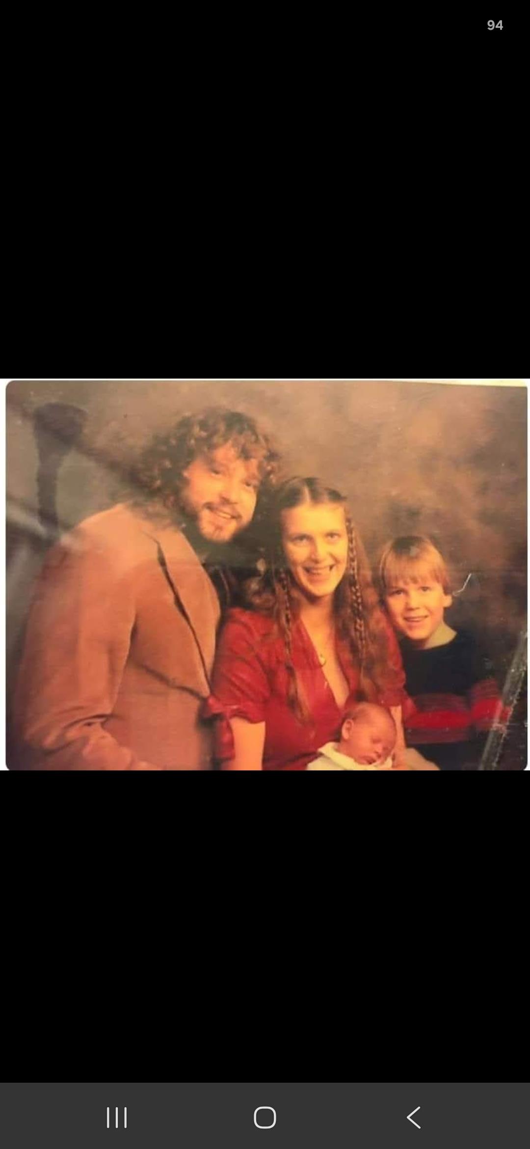 A man and woman holding a baby