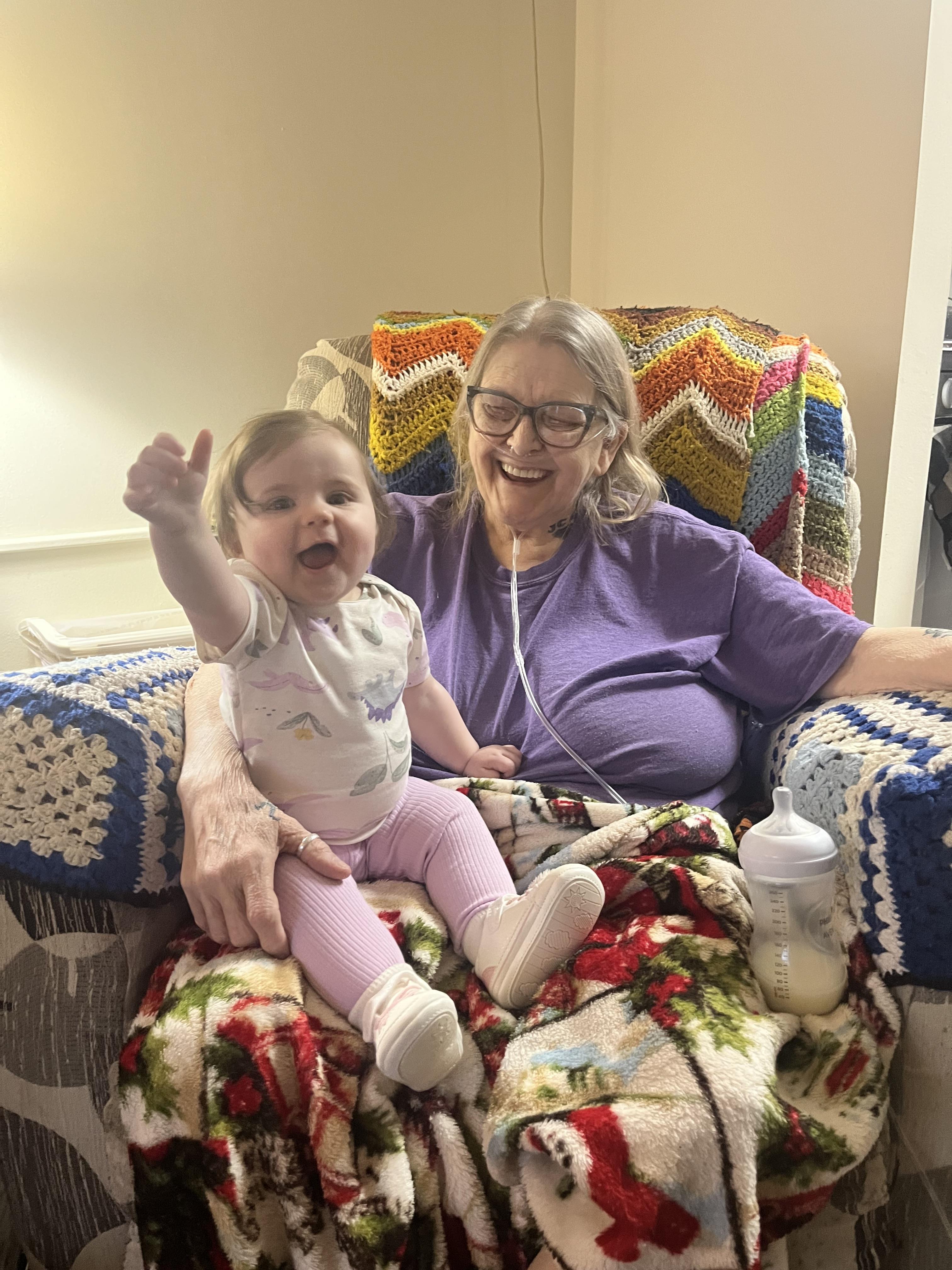 A woman sitting on a chair with a baby