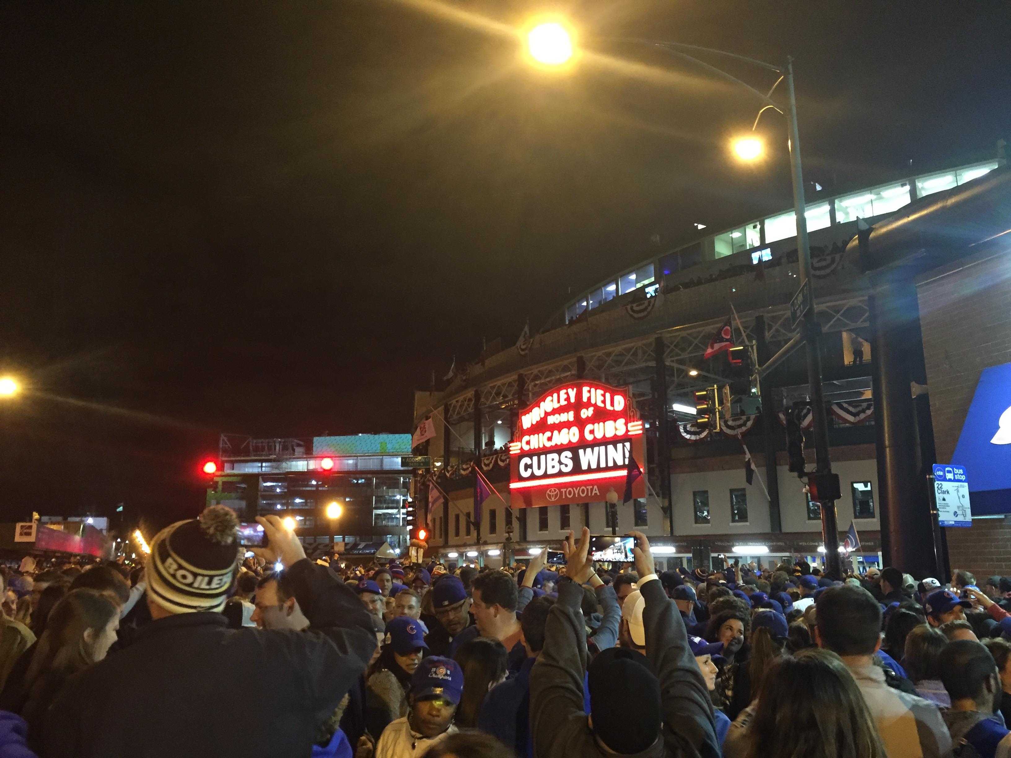 A crowd of people holding up a sign