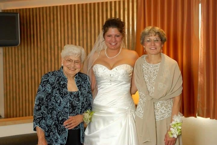 A bride and two older women posing for a photo
