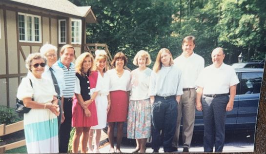 A group of people standing outside a house
