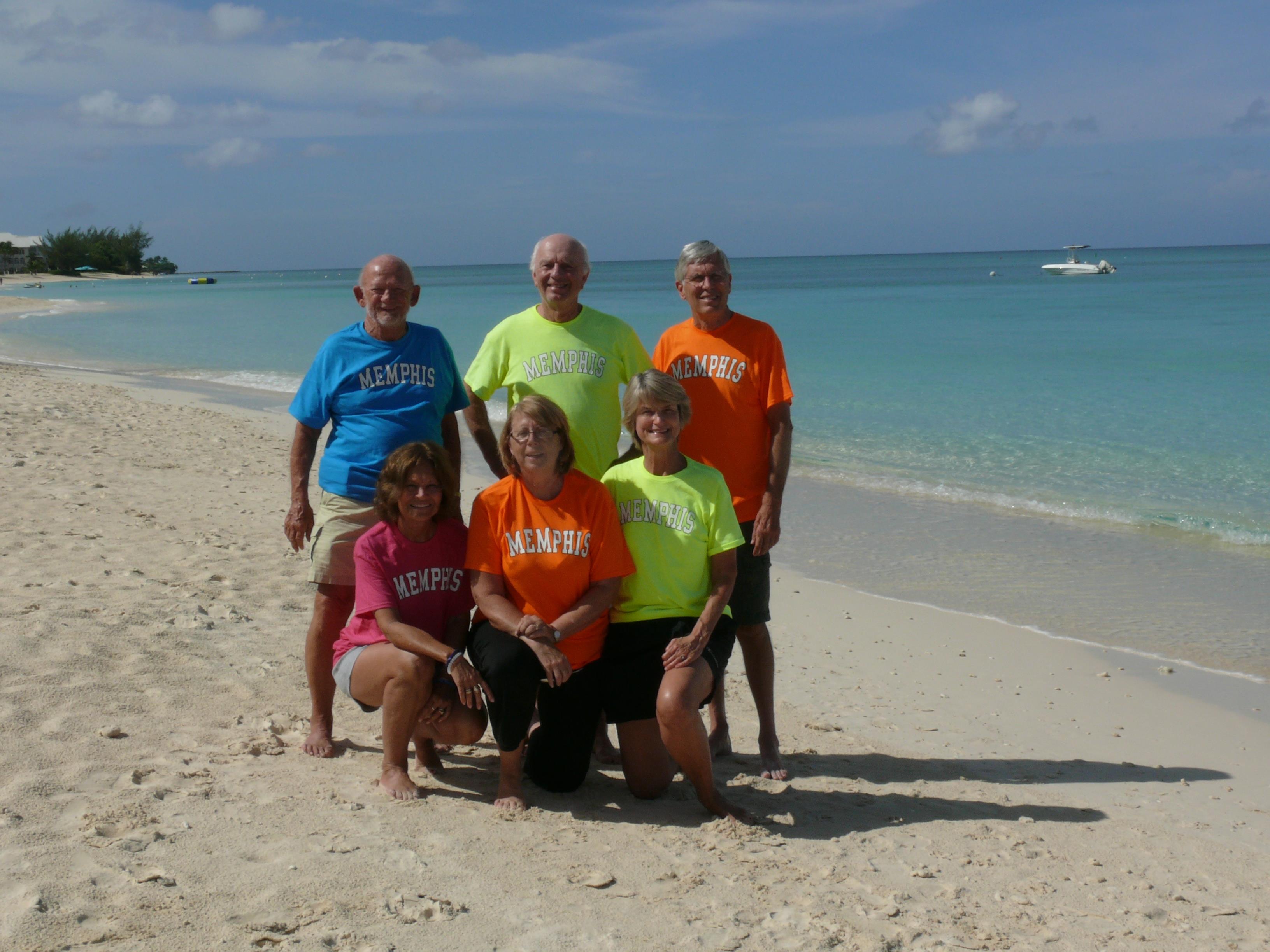 A group of people posing for a photo on a beach