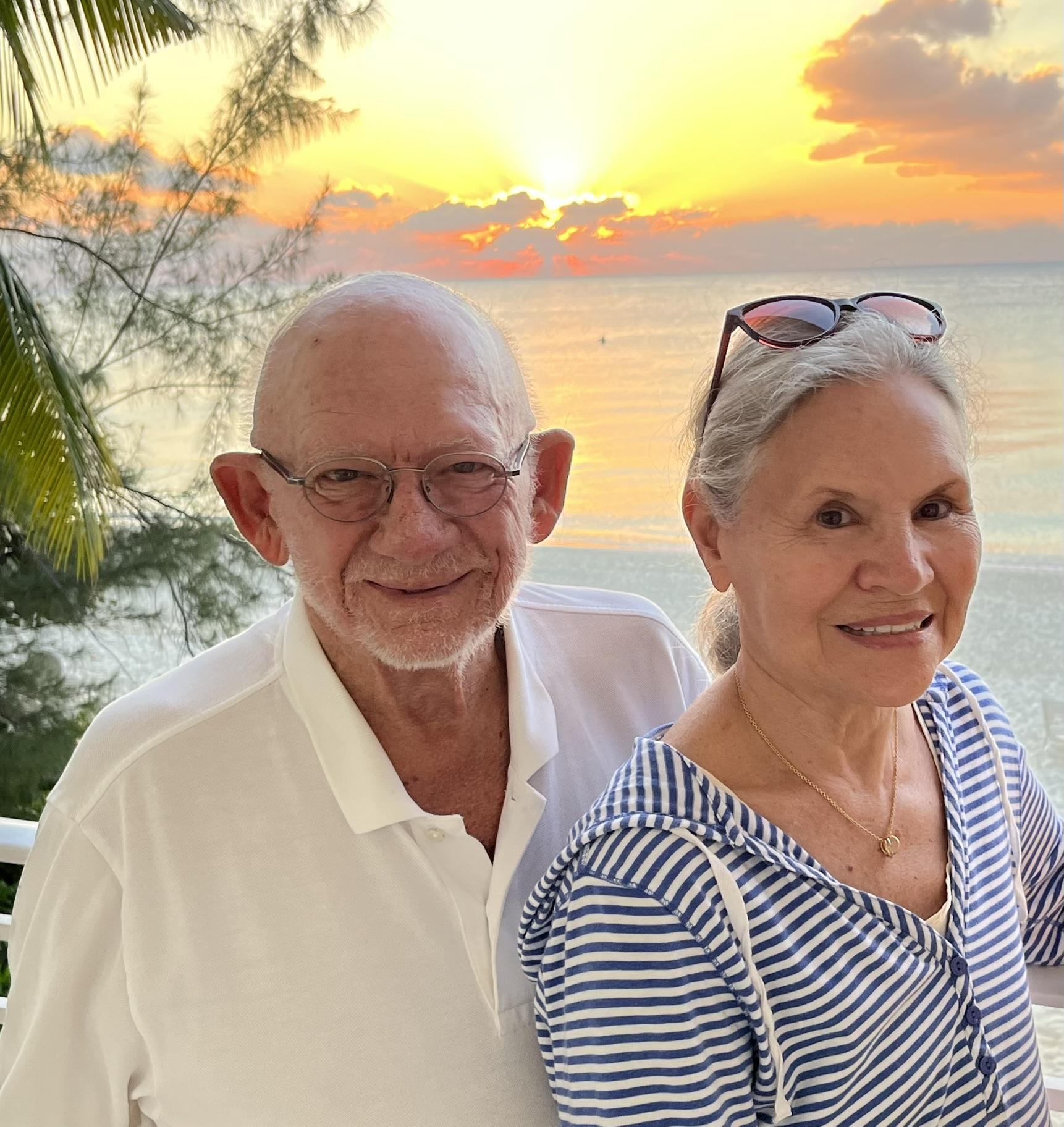 A man and woman standing together on a balcony