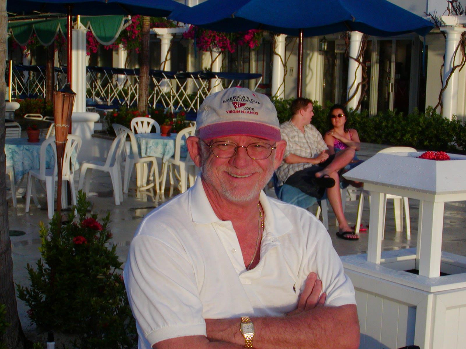 A man wearing a hat and white shirt