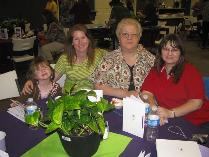 A group of women and a child sitting at a table