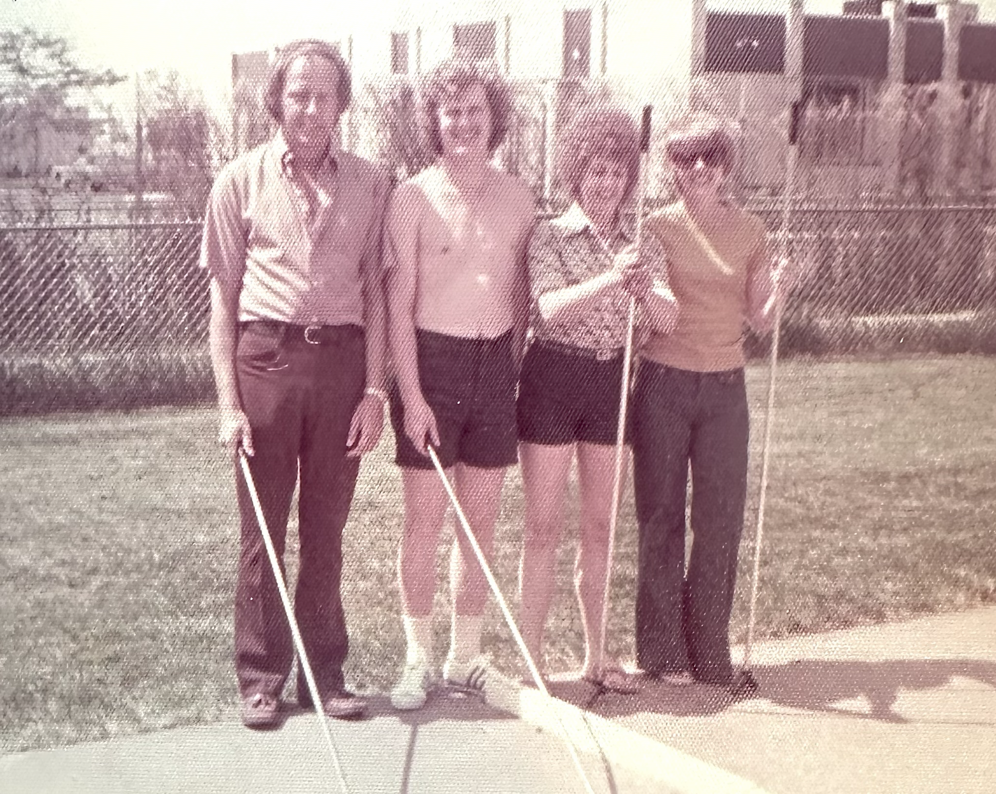 A group of people holding sticks