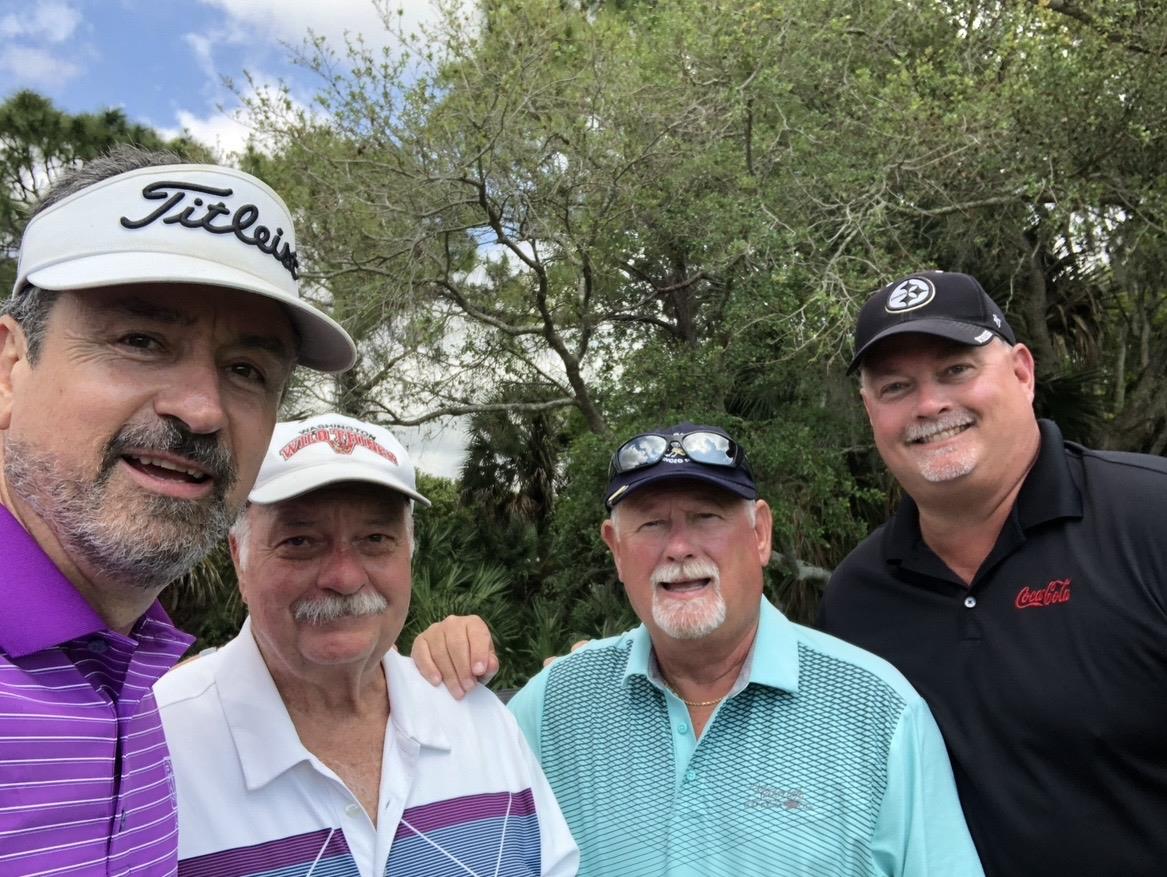 A group of men posing for a picture