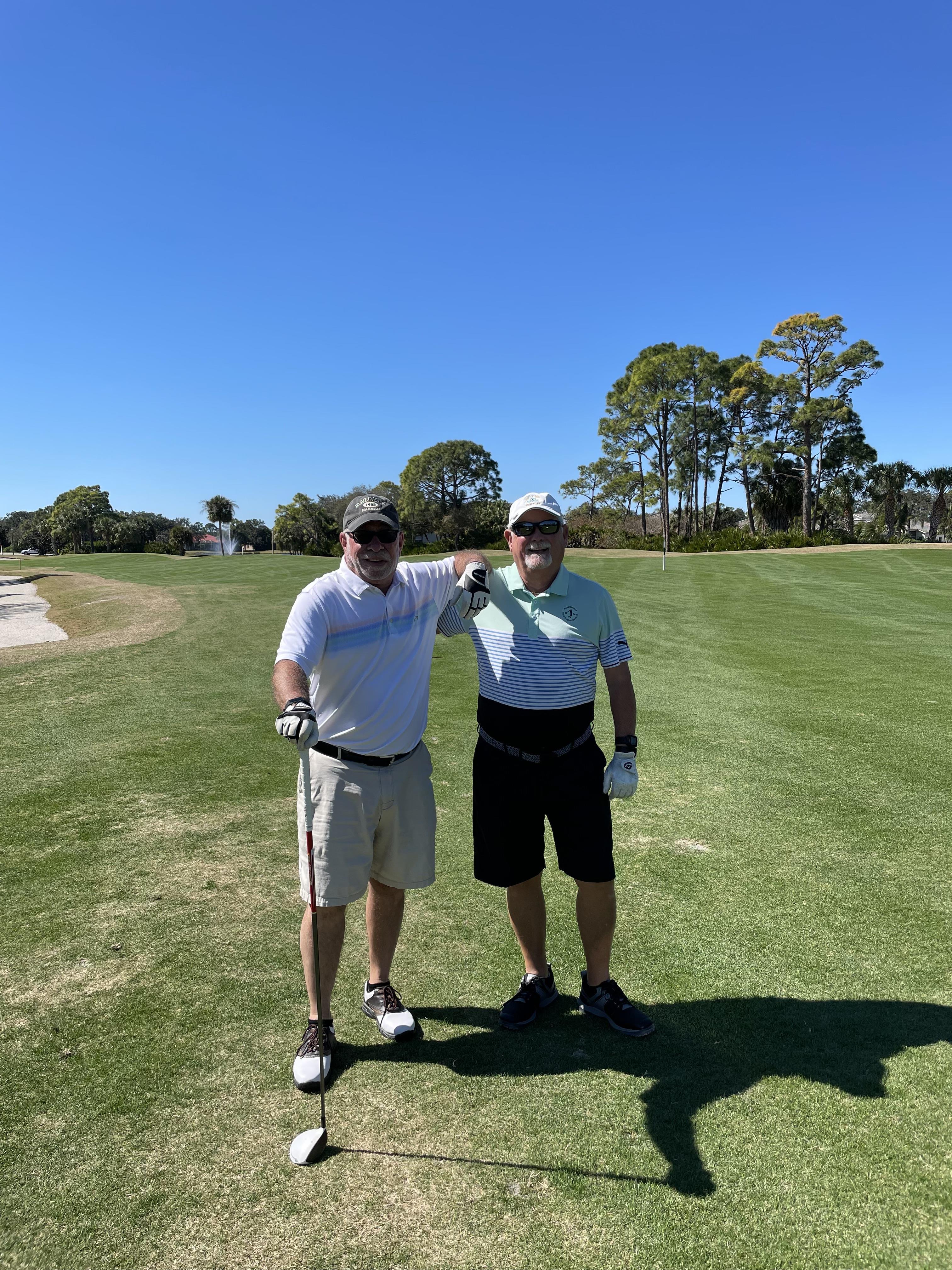 Two men standing on a golf course