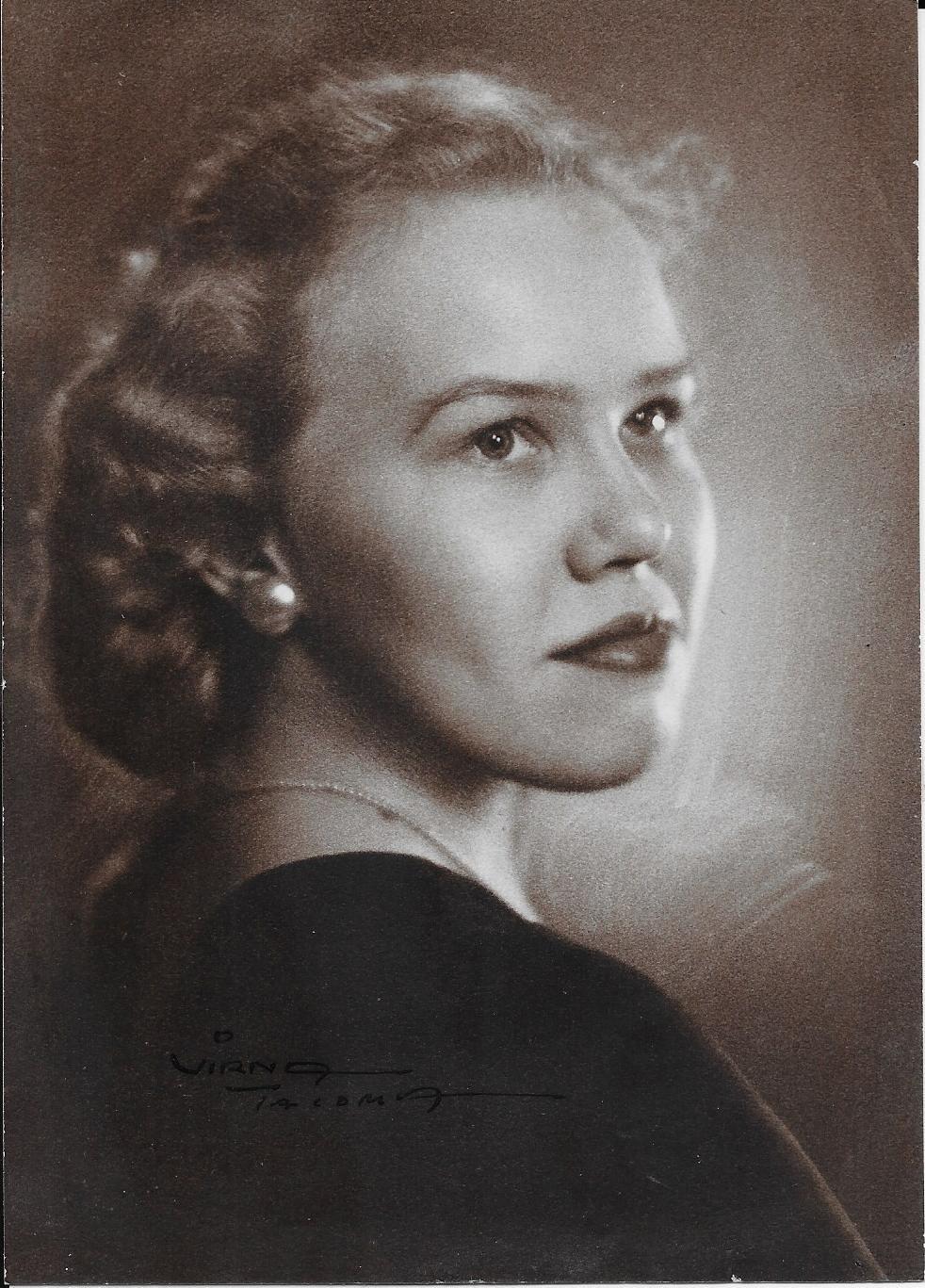 A woman with curly hair and a black shirt