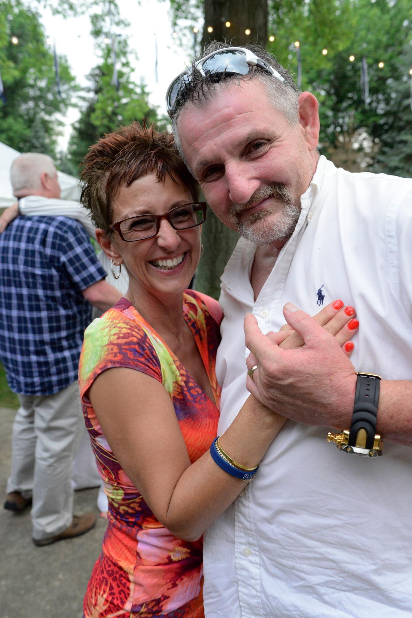 A man and woman smiling at camera