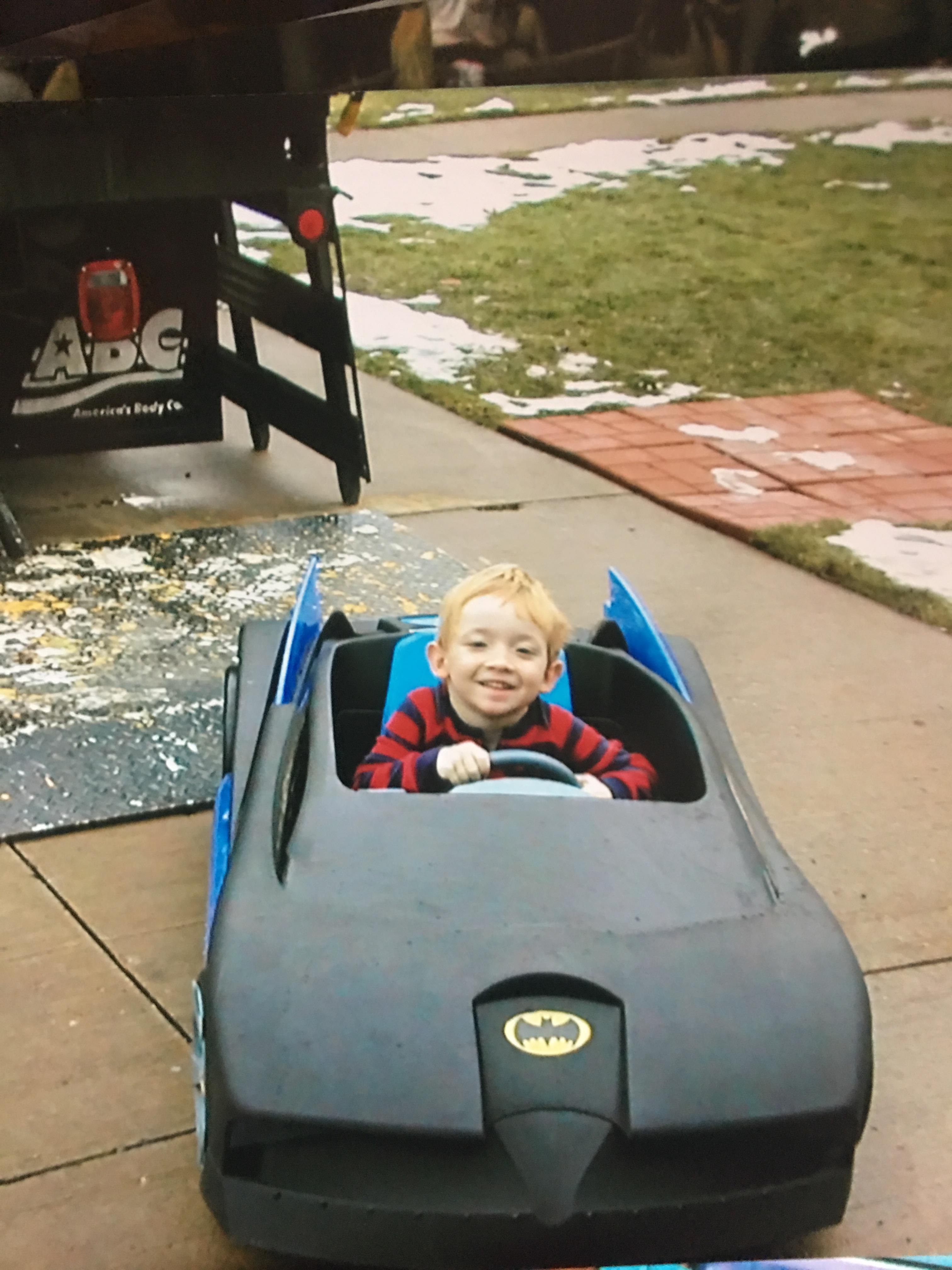 A child in a toy car