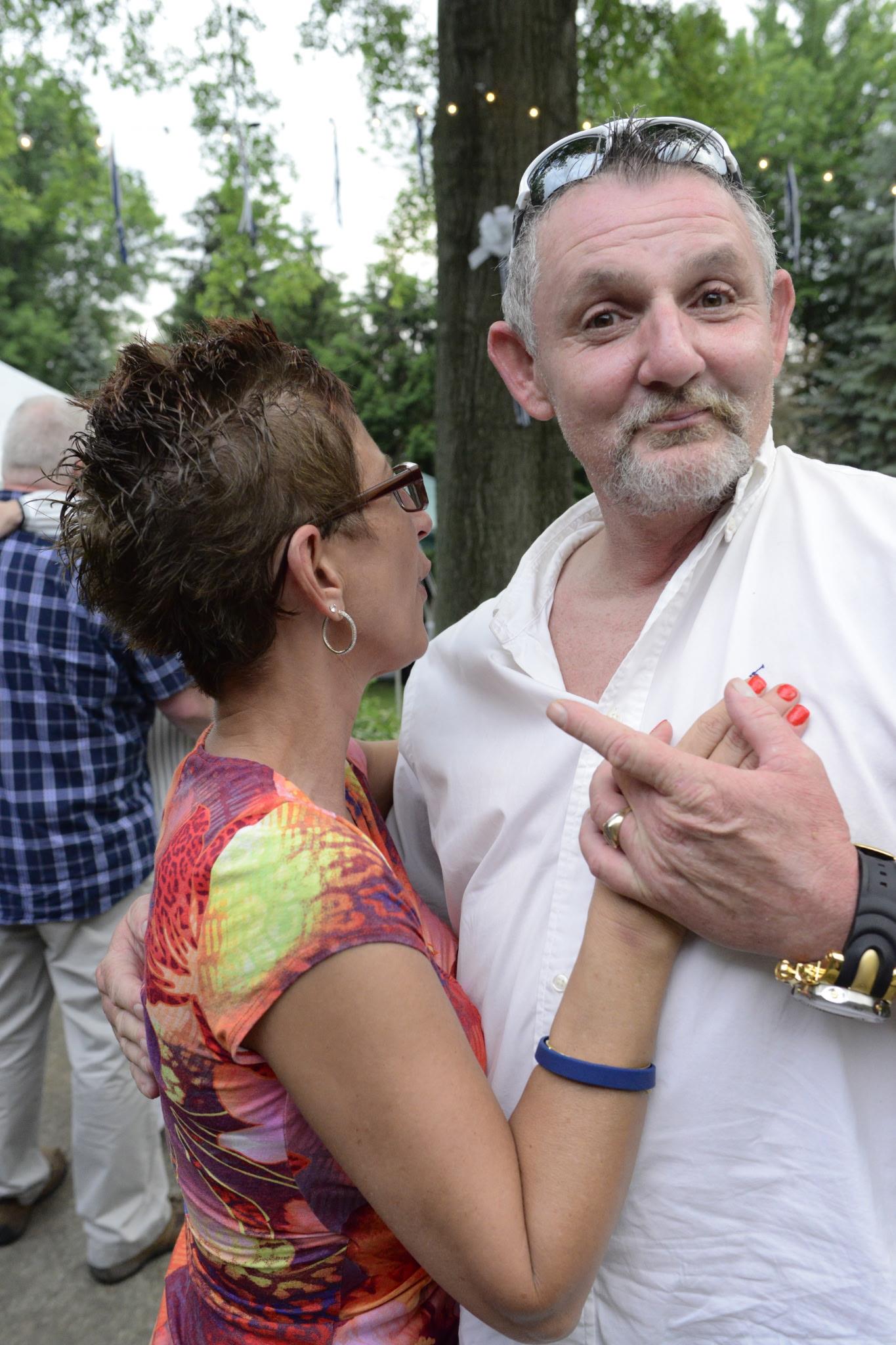 A man and woman standing outside