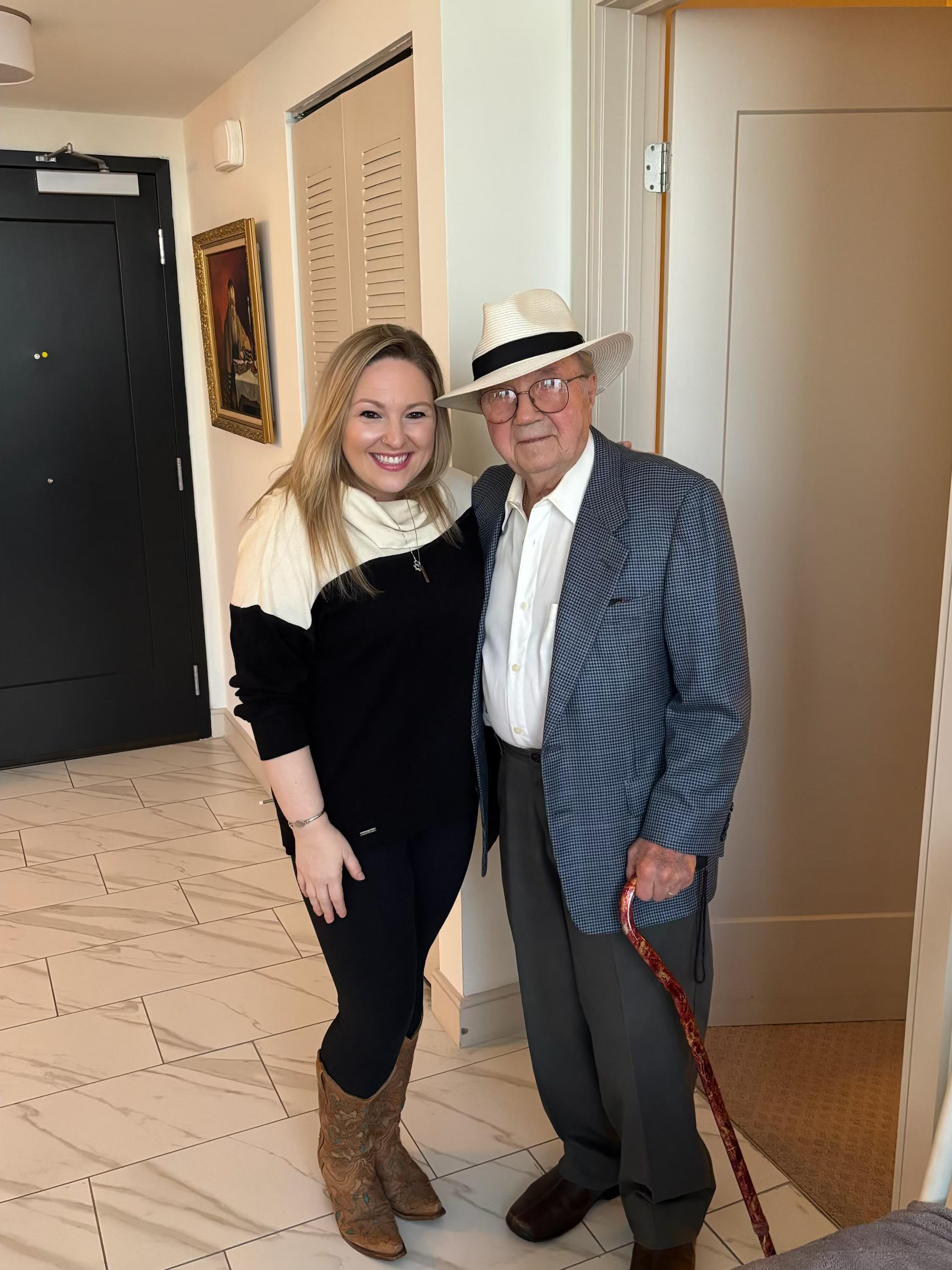A woman and an old man posing for a picture