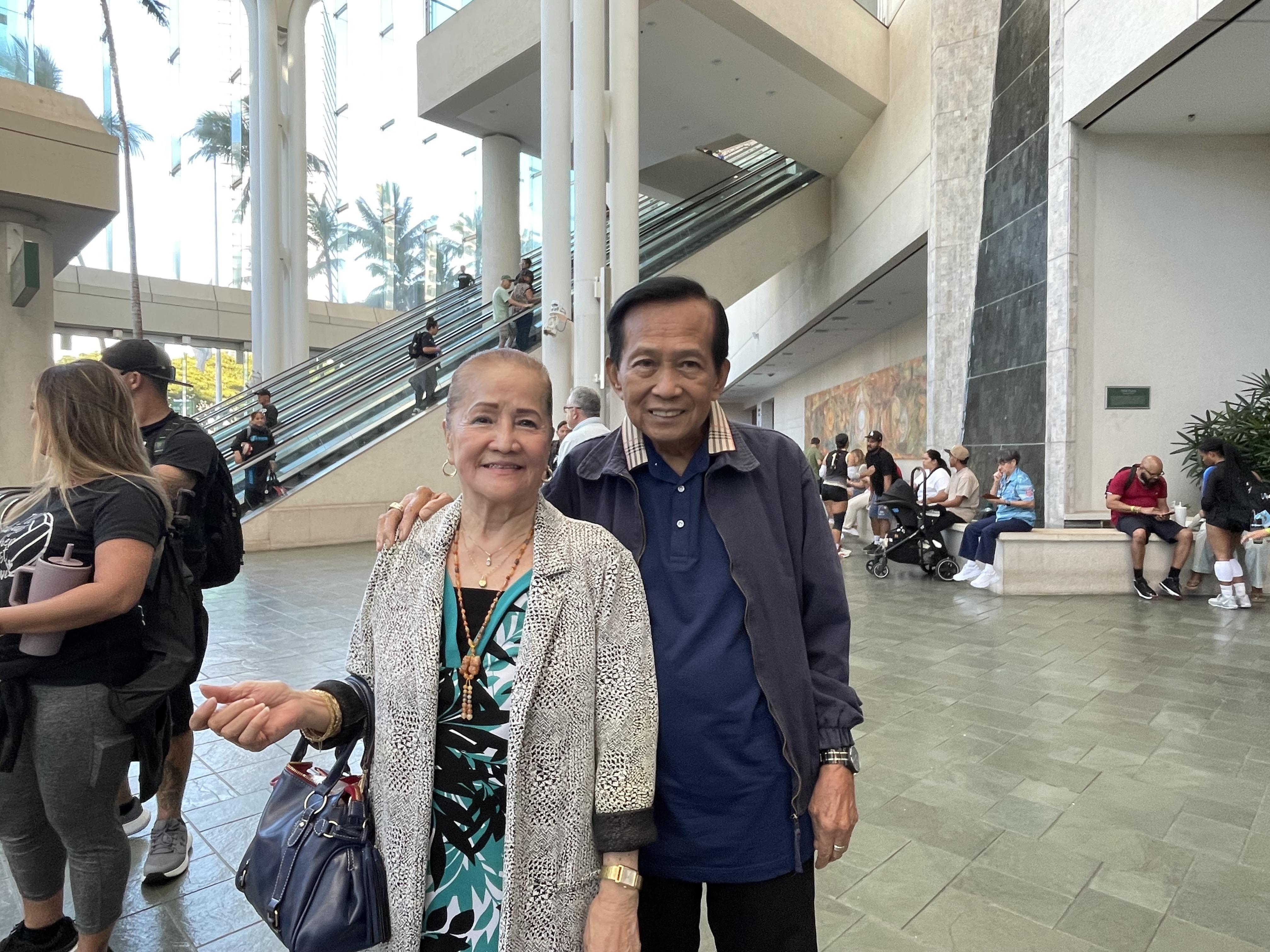 A man and woman standing in a building