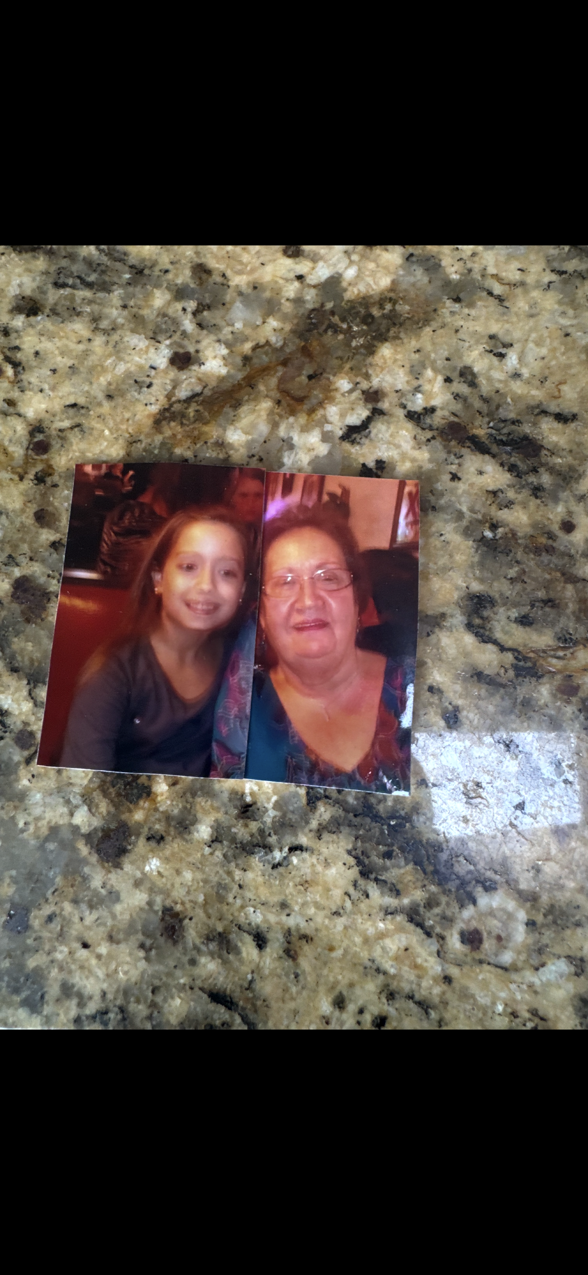 A photo of a woman and a girl on a marble counter