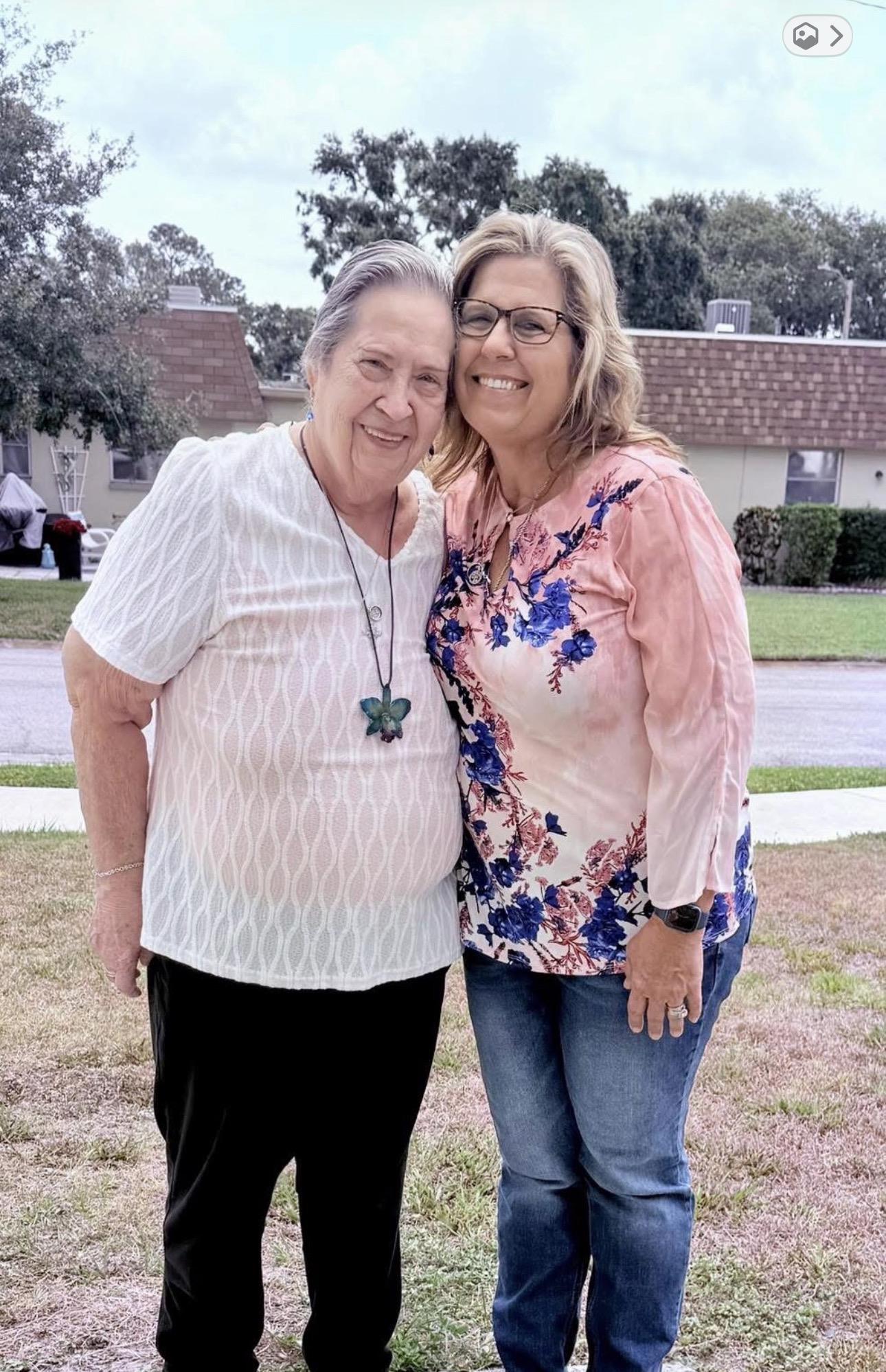 Two women standing together smiling