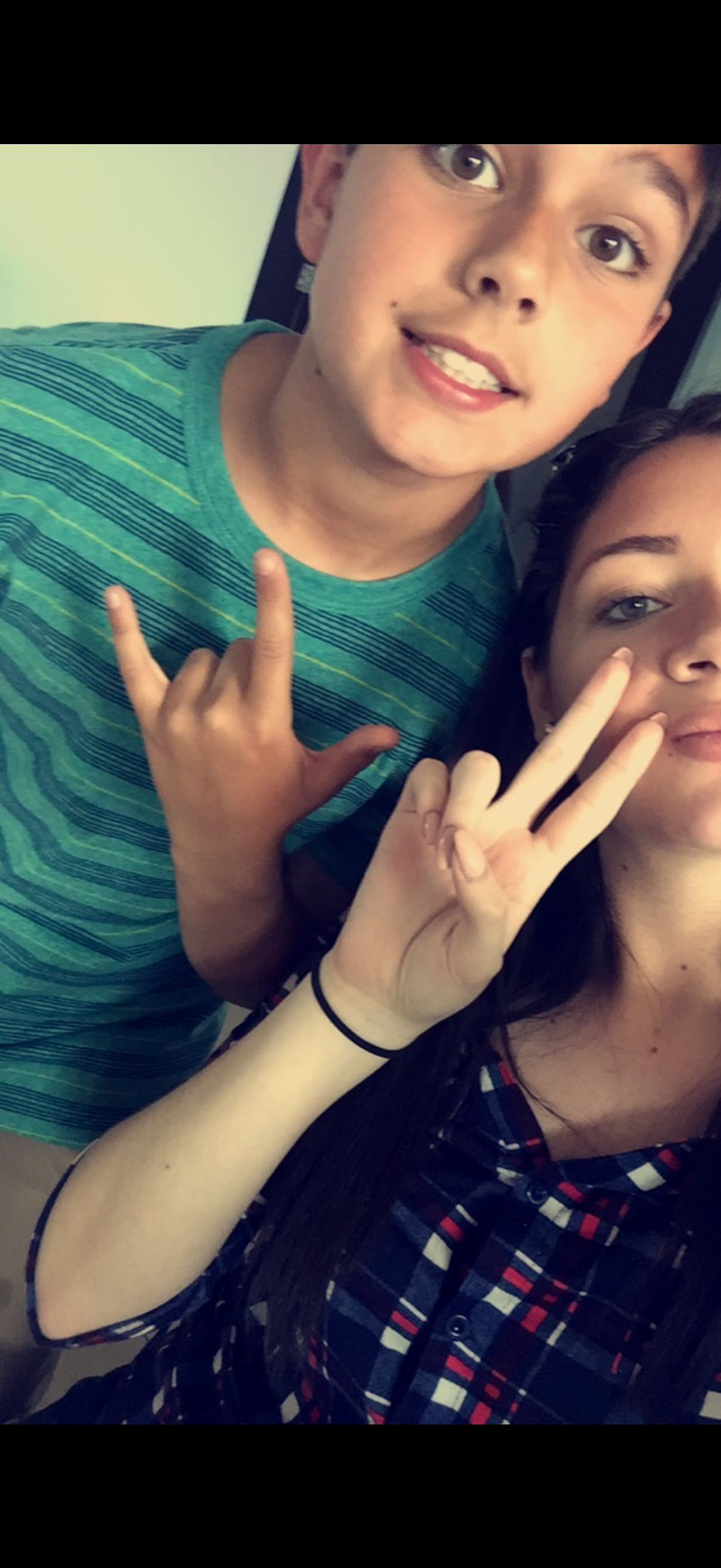 A boy and girl posing for a selfie