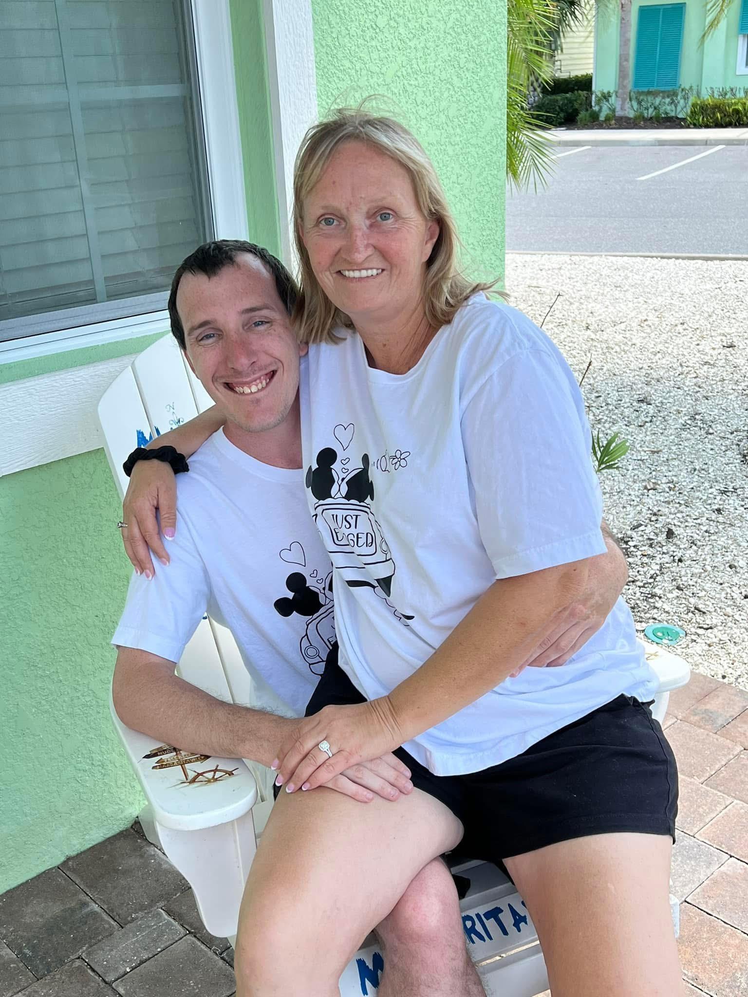A man and woman sitting on a chair